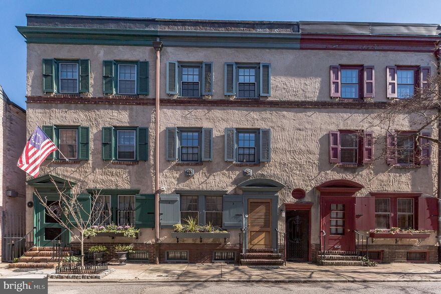 Splendid 2013 Kostas Macos renovation on one of the most desirable and coveted streets in Rittenhouse. Meticulous top quality workmanship and design throughout the home. 2+ years left on the Tax Abatement. The home consists of 3 bedrooms, 3.5 baths, 3 fireplaces, Den, dining room, custom kitchen, finished basement, a slate patio, plus a roof deck. First floor:  Living room with gas burning fireplace, coat closet, dining room with wall of custom built-ins and French doors open to rear slate patio, chefs gourmet kitchen with ample custom cabinetry, marble countertops, stainless Viking refrigerator, Viking 6 burner range, Viking range hood, Viking dishwasher, GE Profile microwave, and a window overlooking the patio. Second floor:  Main bedroom, en-suite, with custom built-ins, private bath with double sinks with granite countertops, walk-in marble shower, hall utility closet with HVAC, spacious front den (could be 4th bedroom)  and windows overlooking Van Pelt Street with a fireplace. Third floor:  Front bedroom with fireplace, full hall bath, rear bedroom en-suite with private bath, hall  staircase up to an amazing roof deck with unobstructed 360 degree views of the cityscape. Basement:  Finished family room/office/exercise room with half bath, laundry closet with stacked washer & dryer, and in the rear is a large storage room with HVAC.   There are wood floors throughout, 2 HVAC systems with 3 zones, and a monitored video security system.