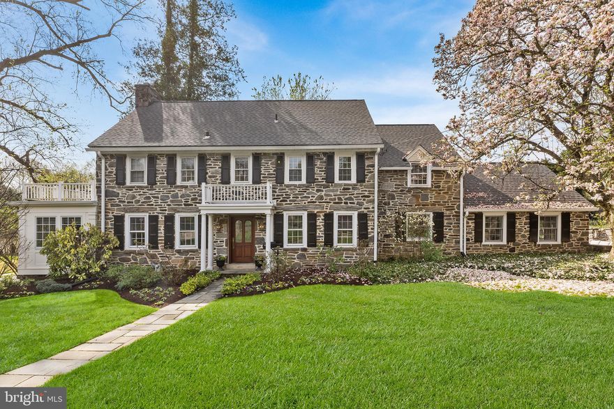 A rare offering in the heart of Bala Cynwyd, where 1930 stone colonial craftsmanship meets a
beautifully curated modern interior on one of the neighborhood's most coveted corner lots. Set behind
stately rod iron fencing, this magnificent residence offers historic character, flexible modern living,
and an address in the award-winning Lower Merion School District. Pass through the iron gate and
follow the walkway to one of the most memorable front doors in the neighborhood. Step into a
welcoming foyer where the home's exceptional layout immediately reveals itself. To the left, a gracious
formal living room anchored by a wood-burning fireplace flows into a sun-drenched home office and
study addition, wrapped in two walls of oversized windows that pour in natural light, ideal for today's
work-from-home lifestyle. To the right, a formal dining room impresses with built-in cabinetry,
generous window sills, and a stunning chandelier casting the room in warm, elegant light. Step
through the swing door into the heart of the home: a large eat-in kitchen refreshed for 2026 with
Calacatta Miraggio Gold quartz countertops, crisp white tile backsplash, new cooktop, and an
undermount sink framed by a picture window overlooking the front yard. The open-concept flow
continues into a dramatic great room with soaring ceilings, a second fireplace, and flanking built-ins
that deliver both grandeur and everyday function. French doors open to a private side patio wrapped in
a stunning stone surround, a true outdoor space perfect for al fresco entertaining. A large laundry
room and powder room complete the first floor. Upstairs, the center staircase leads to an ideal
bedroom layout. The primary suite offers a generous closet and a spa-inspired ensuite, soaking tub, and separate shower. Three additional large bedrooms share a well-appointed hall
bathroom, each offering scale and proportion rarely found in newer construction. A secondary
staircase leads to the finished attic, a versatile flex space functioning beautifully as a fifth bedroom,
playroom, or studio, with an additional bathroom and closet. The finished basement provides space for
a media room, home gym, or recreation area, connecting directly to the attached garage with EV
charger. A French drain system and abundant storage make this lower level as practical as it is livable.
Freshly painted throughout, new light fixtures, and updated in all the right places while honoring the
soul of its 1930 origins, 86 E Princeton Road is Bala Cynwyd Main Line living at its finest. Walk to shops,
restaurants, and the Cynwyd Heritage Trail.