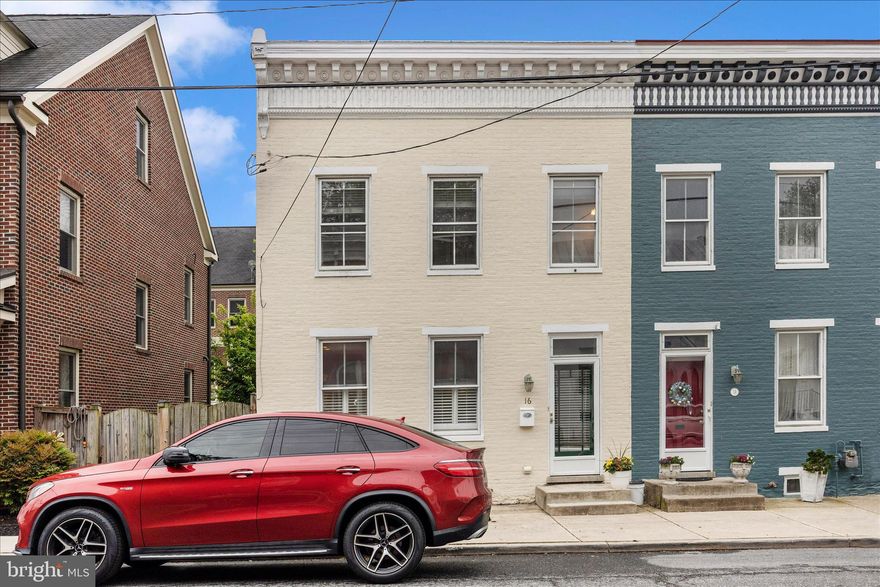 Gracefully blending historic charm with modern convenience, this beautifully renovated downtown Frederick row home offers the character you will love and the comforts you rarely find.
Located just one block from Market Street in the heart of downtown Frederick, this exceptional semi-attached home was thoughtfully renovated to preserve its original soul while introducing the features today’s homeowners desire. Even more rare for downtown living—this property includes two assigned off-street parking spaces.
Step inside and feel immediately at home among rich hardwood floors, timeless architectural details, and beautifully curated finishes. The kitchen is both elegant and functional, featuring furniture-quality custom cabinetry with inset doors and drawers, granite countertops, stainless steel appliances, a center island, and a sunlit window over the sink—creating a space equally suited for quiet mornings or lively gatherings. A main-level half bath, main-level laundry, and practical mudroom entry add thoughtful convenience to daily life.
The spacious living and dining area is a true showpiece, where a coffered ceiling, custom plantation shutters, and gas fireplace create warmth, sophistication, and inviting ambiance. The original Victorian newel post stands proudly as a beautiful reminder of the home’s heritage, adding authentic character that cannot be replicated.
Upstairs, the primary suite offers a walk-in closet and private ensuite bath featuring a jetted tub and tile surround. Two additional generously sized bedrooms and a second full bath provide flexibility for guests, family, or office space.
With historic elegance, gas heat, central air, excellent closet space, multiple baths, off-street parking, and walkable access to shops and restaurants, this home offers an exceptional opportunity to enjoy downtown living without compromise.