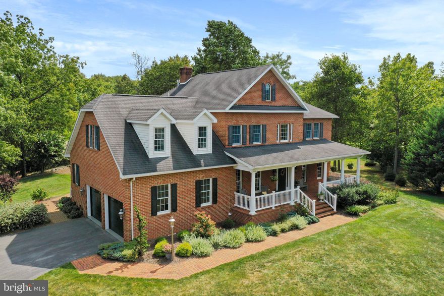 Exquisitely maintained, all brick,5 Bedroom home with a bonus room/study on the 2nd floor and 3 full bathrooms.  Both  the main level and  2nd floor have oak hardwood floors throughout.  The main level  opens to a grand, open foyer with a balcony.  9' ceilings with stacked crown molding including fluted trim with rosettes adorn the first floor. The main level includes the formal dining room, formal living area with custom shelving, 1st floor bedroom. full bathroom with custom tile shower, large central  living area with gas fireplace and  8' French doors that open top the back porch and patio area, separate screened porch with dedicated entrance, ceiling fan, slate tile floor and tongued and groove ceiling, kitchen with 7.5' island, quartz counter tops, 42" Cherry cabinets, tile back splash, double wall oven, cook top and stainless steel appliances. Finishing the main level is a large mudroom off the 2 car oversized garage with sink and cabinets. The 2nd floor has 2 staircases. 1 from the foyer entry and 2nd staircase from the kitchen area.  4 Bedrooms plus a carpeted study/den. The primary suite includes siting area, trey ceiling and an absolutely fabulous bathroom. 2 separate vanities, large glass block window, toilet closet, linen closet, walk-in closet and walk-in custom tile and glass shower.  The basement level has enough space to create a gym or movie room plus a brick hearth with a flu for a woodstove. Large storage room a plus a work shop complete with a double door walk-out on the basement level.  Outside the French doors to the backyard is a phenomenal patio/entertaining area.  The brick patio is 26'x18' and sits beside the beautiful running  stone stream and pond with 3 waterfalls. To the back of the property is the 2 Bay workshop (30'x50')which has a separate driveway and is less than 5 years old . 10' bay doors and 12' ceilings in the workshop with electric and woodstove for heat.  A great place to park you RV or work on your hobby cars. There is also an additional 2 bay garage/shed (24'x24') near the house and a 6' fenced flower, vegetable and raspberry garden. All on over 4.5 acres