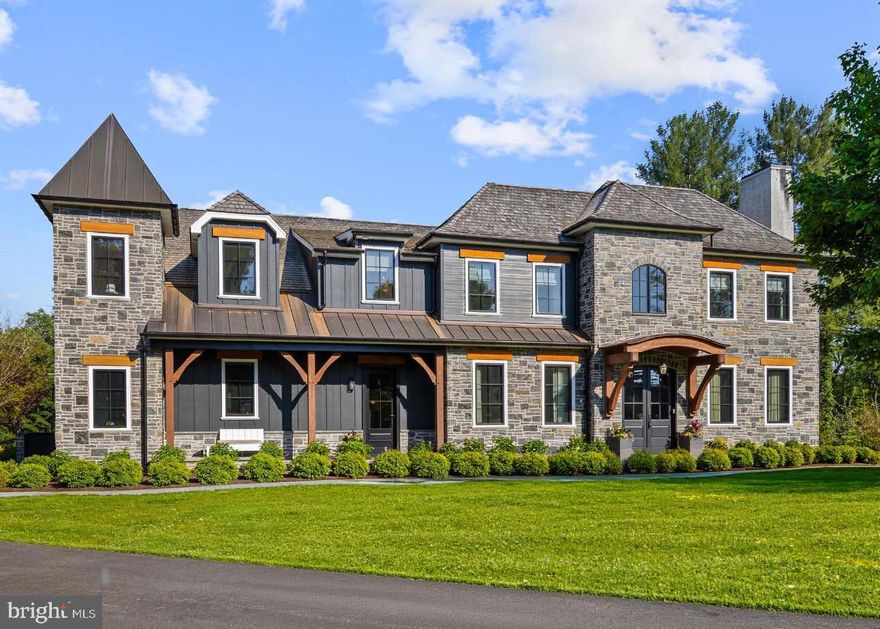 Located in prestigious Villanova and tucked along a charming private lane at the end of a cul-de-sac, this exceptional recently constructed residence embodies sophisticated modern living.  One of only 8 homes in the neighborhood and anchored in the award-winning Radnor Township School District, this home is a not-to-be missed Main Line gem.  Offering 5 bedrooms, 5 full baths and 2 half baths, the home is thoughtfully designed with expansive open-concept spaces and elevated finishes throughout.  A dramatic foyer welcomes you, elegantly flanked by a stunning dining room and a refined living room/study with a gas fireplace marble surround. The foyer leads effortlessly to an open concept kitchen and family room offering the perfect setting for both everyday living and entertaining.  The kitchen is appointed with premium Thermador appliances, quartz countertops, a large center island, a stylish wet bar/butler pantry. The sunlit breakfast room boasts a vaulted shiplap ceiling with wood beams and opens to a spacious rear deck. Discreetly tucked behind a hidden door, a caterer's kitchen provides privacy and convenience for hosting on any scale. Designed with functionality in mind, the mudroom features a separate entrance, custom built-ins, easy access to a powder room and a back staircase.  From the foyer a sweeping curved staircase leads to the luxurious primary suite with a gas fireplace and a spa-inspired bathroom featuring a wet-room layout including an advanced Kohler shower system, oversized glass enclosed shower and freestanding soaking tub. An expansive custom walk-in closet with a large center island offers abundant storage space.  Two large bedrooms with private en-suite bathrooms as well as a two-bedroom Jack- and-Jill suite with a shared bath, and a laundry room complete the second level. The fully finished lower level offers an impressive extension of living space, including a family recreation room, custom bar, private office, fitness room, second laundry room, full bathroom, a custom dog shower and abundant storage.  A charming children’s playhouse tucked beneath the staircase adds a whimsical touch. Sliding glass doors lead to an expansive patio and resort-inspired saltwater pool, artfully built using dramatic flagstone slabs, cascading waterfalls, and professionally landscaped surroundings with layered privacy plantings and ample backyard lawn for games and family activities. The attached 3 car garage has high ceilings and an organized storage system.  Located just minutes from upscale shopping, dining, major highways, the Blue Route, Philadelphia and the PHL airport, this remarkable property offers luxury living in one of the Main Line’s most coveted locations.