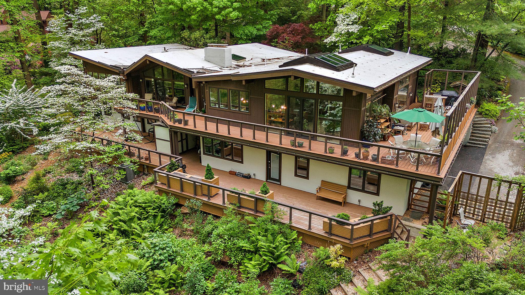 Welcome to 5 Clark Dr. in Newtown Square's well established Community of Green Countrie where luxury and tranquility converge. Hear the peaceful sound of the waterful from the koi pond as you walk to the main entrance.
The picturesque main living room with architectural floor to ceiling windows provide views of the botanical gardens. Stone fireplace accents the living room and can be enjoyed from the dining room as well.
Gourmet kitchen features thermador double ovens with steam cooking and convection features, six burner gas cook top and sub zero refrigerator.
Dining area also features cutom built in desk/family workstation and great room all adorned in natural light.
For the master gardener or home owner wishing to create their own organic vegetables, the plant room is a beautiful, conditioned space complete with drainage.
Ceramic tiled flooring is heated for comfort on the main level.
Primary en-suite is located on the main level, with both a walk in shower and additional full bath.
Lower level offers an in-law/aupair suite with private entrance and a f ull ceramic tiled bath.
In home office with stone fireplace and sitting room is also accessible by private entrance.
Two additional bedrooms, full bath, cedar closet, family room, workshop, fitness area, kitchenette and an abundance of storage complete the lower level.
Elevator enables access between floors with ease.
This mid century modern masterpiece was designed by Paul L'Esperance with a custom crafted addition contructed by Rudloff Bldrs in 2017.
The manicured garden, deck and ponds will have you feeling peaceful in your own paradise.
Convenient to Center City Philadelphia, Phila. International Airport, Whole Foods, the esteemed Episcopal Academy and minutes to shopping and dining in downtown Wayne.
This home offers luxury and convenience and so many possibilites!