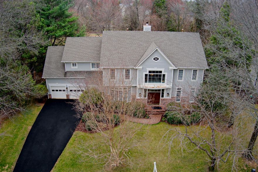 HUGE price reduction! If you have been considering a move this new price gives you options.  From the moment you step through the double doors of this stunning North Reston home, you'll feel why this home is special.  A soaring two-story foyer makes a grand first impression, flanked by dual coat closets — one for family, one for guests — and anchored by an elegant hardwood staircase. A chandelier, with a built-in lift, adds a thoughtful, practical touch to this beautiful entry.
The main level is designed for both everyday living and effortless entertaining. A formal dining room with floor-to-ceiling windows and a built-in alcove sets the stage for memorable dinners, while the living room offers a refined space for gatherings or quiet evenings in. A dedicated home office with custom built-in bookcases provides an ideal work-from-home retreat, and the beautifully proportioned family room centers around a gorgeous gas fireplace. The well-designed kitchen is a true gathering spot. Newly installed hardwood oak flooring flows throughout the main level and up the staircase to include the upper level.
Upstairs, the expansive primary suite is nothing short of spectacular — featuring a generous sitting area, multiple walk-in closets, and a spa-caliber bathroom with double sinks, a heated surface soaking tub, heated floors, a heated toilet seat, and a large shower with bench and a rain head. Two additional bedrooms share an updated jack-and-jill bath, and a fourth en suite bedroom offers privacy and comfort. A large, versatile three-sided bonus room at the top of the stairs adapts beautifully to whatever you need — bedroom, playroom, office, or studio. The light is fantastic! 
The lower level is an entertainer's dream, offering a spacious rec room (large enough for a pool table), a step-down media room, a mirrored exercise room, and a sixth bedroom with egress window.
Outdoor entertaining will be on your list with the large composite deck, accessed from either the breakfast room or the family room. Sitting outside enjoying your morning coffee or reading a book in the afternoon is easy to imagine! The travertine walkway meanders to signicant additional lot space for games or activities (think soccer, bocce, lacrosse, corn hole, volleyball). The lot is very private and the large lot means there is a lot of distance between this house and any behind. Outside the front door, life is equally convenient — minutes from Route 7, Dulles Airport, and Reston Town Center, with easy access to walking and biking trails, community pools, tennis courts, Metro, and an abundance of shopping and dining including Trader Joe's, Starbucks, and local favorites for every craving. Beautifully updated and lovingly maintained, this home is move-in ready!
Property plat available in the Documents section.
