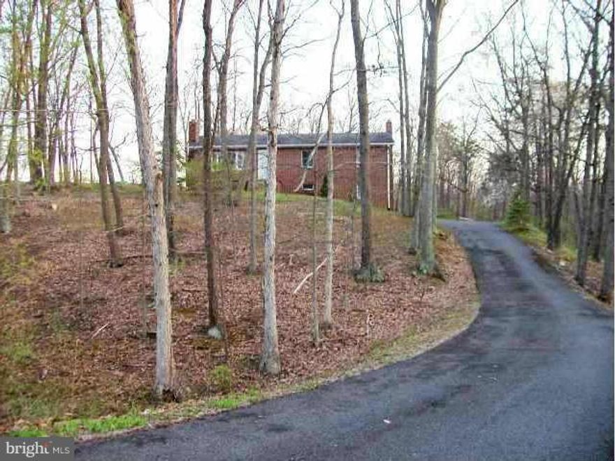 Bring us a Reasonable  offer on this Rock Solid 3Br. 2.5Ba.  Brick Rancher on a walk out level basement, all on TEN ACRES of Unrestricted QUALITY LAND that borders larger tracts & offers Unbelievable Privacy! GREAT Hunting & a great 2nd home site.  Super Location on Front Royal Pike. Nice setting off of the road.  Features: newer roof,  paved driveway, 2 Wood Stove's, Hardwood flooring, & more.