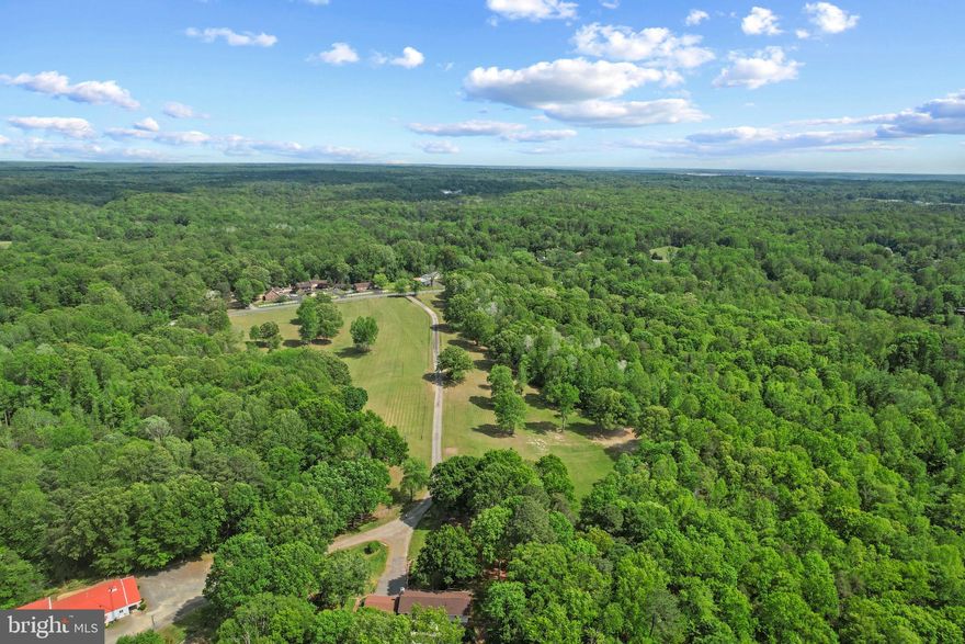 Zoned Agricultural, his 55.67-acre (3 parcels) property offers flexibility. The Seller used the property for a thriving Tree Service business, but it offers flexibility for a new Buyer. A private pond and creek add natural beauty and tranquility to the landscape, perfect for wildlife watchers and nature lovers. An additional parcel nearby with community water access rights to Potomac Creek and the Potomac River is available, featuring a boat ramp and day pier — ideal for boaters. 

It has a private oasis that combines modern comforts with rural charm, perfect for buyers seeking a retreat that is both tranquil and full of potential. A 4-bedroom, 2-bath bungalow with spacious main bedroom and spa-inspired bath is the heart of this property. The oversized main bedroom is a true sanctuary, featuring a walk-in closet and an attached bath with marble tiles, a double vanity, walk-in spa shower, and jetted soaking tub — ideal for relaxing after a long day. The kitchen is a chef’s dream, with a large central island, granite countertops, stainless steel appliances, and a Viking range hood (new motor 2023). The kitchen opens seamlessly to the family and dining areas, offering the perfect flow for entertaining or family gatherings.  Motivated Seller. 

Outside, the property is an entertainer’s dream. The hot tub and heated saltwater pool surrounded by beautiful decking create a peaceful space to relax or host friends and family. A pool house features a bar area with a sink, refrigerator, and ice maker, as well as a small kitchen, half bathroom, and poolside outdoor shower — perfect for outdoor gatherings or relaxing escapes. The high-bay shop building is a offers flexibility in vehicle and equipment maintenance with space for up to 7 large vehicles, a 10K lb lift, tool cages, a commercial auto vacuum, a restroom, and a wood stove for added warmth during winter months. The shop has a separate office area, with a half-bath, and a 900 lb ice maker. Under the same roof, there is a 2-bedroom apartment with walk-in closets, an eat-in kitchen, living room, and a washer and dryer — providing ideal space for guests or potential rental income.

The home has received several updates to ensure modern comfort, including a new architectural shingle roof (2025), a new heat pump (2023), and a new vinyl pool liner (2023). The exterior of the home is constructed with Hardie Board siding, known for its durability and low maintenance. Utilities include a private 8-inch drilled well (300+ feet deep) with a filtration and conditioning system, a 4-bedroom septic system (per seller), and 200 amp electric service at both the house and shop. Verizon FiOS high-speed broadband is available, a rarity in the area, providing excellent internet access for work or leisure.

This remarkable property is partially wooded, providing privacy and room to roam. The friendly Labrador dogs on the property will typically be secured in the shop office during showings, but they may bark to alert arrivals — they are not aggressive, but caution is advised. There is a lumber mill in a small shelter beyond the shop, which does not convey with the real estate sale but may be purchased separately if desired.

A perfect combination of work-near-home flexibility and relaxing retreat, this property offers the best of both worlds. Whether you're a car enthusiast, hobbyist, small business owner, or simply someone seeking a private sanctuary to enjoy nature, relaxation, and modern luxury, this offering is sure to exceed your expectations. Located just minutes from town conveniences, yet nestled in its own private world, the possibilities are endless. Don’t miss the chance to make this exceptional property your new home.
Additional Parcel Available with optional boat ramp access to Potomac Creek.
Potential Uses are suggestions, Buyer should confirm with County Board intended use.