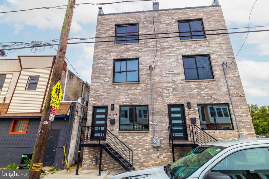 A Stunning Custom-Built New Construction Home in South Philadelphia! This thoughtfully designed residence offers the perfect blend of modern elegance, smart home technology, and high-end finishes—complete with a 10-year tax abatement and a 1-year builder’s warranty for peace of mind. Step inside to find a spacious first floor featuring a bright living room with a cozy fireplace, an open staircase with sleek glass railings and step lighting, and a dining area that flows seamlessly into the gourmet kitchen. The chef’s kitchen boasts a waterfall quartz island, stainless steel appliances, under-cabinet lighting, and sliding doors that open to the private backyard—ideal for entertaining. The second floor offers two generously sized bedrooms, a full bathroom, and a convenient laundry area. Upstairs, the private third-floor primary suite impresses with cove lighting, a walk-in closet, and a luxurious spa-like bathroom complete with a freestanding soaking tub, a walk-in shower, and a double vanity. Take the staircase up to the rooftop deck, where glass railings frame breathtaking panoramic views of the city skyline. The finished basement expands your living space with a full bathroom and stand-up shower, making it perfect for a guest suite, home office, or gym. This home is equipped with smart home features, including built-in speakers, an exterior security camera, and a Wi-Fi–enabled dual-zone HVAC system for maximum comfort and convenience.