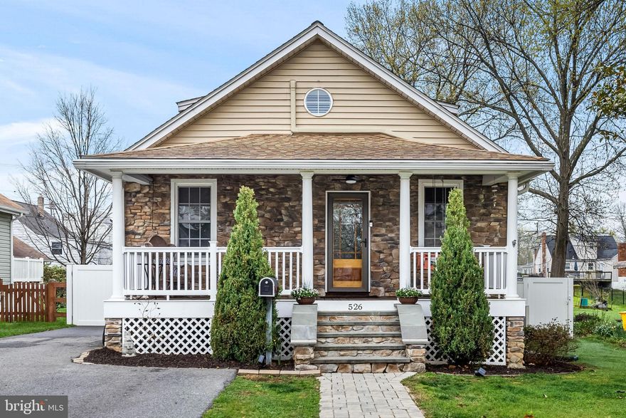 Beautifully Renovated Cape Cod in Linthicum Heights

Built in 1924 and thoughtfully renovated for modern living, this charming Cape Cod blends historic character with the comfort and convenience today’s homeowners appreciate.

As you approach the home, wide stone steps rise gently from the paver walkway, leading to a welcoming covered front porch that stretches across the front of the house. Supported by Craftsman-style columns and framed by a striking stone façade, the porch creates the perfect place to relax with a morning coffee or greet neighbors passing by. Dormer windows and a steeply pitched roof preserve the home’s classic Cape Cod charm while updated siding provides durability and easy maintenance.

Step inside and you are greeted by bright, open living spaces with 9-foot ceilings, recessed lighting, and elegant decorative moldings that give the home both warmth and architectural character. White plantation shutters filter natural light throughout the living areas, while hardwood flooring adds style and long term value. The living and dining areas flow effortlessly together, creating an inviting space for gathering with family or entertaining guests.

At the heart of the home, the beautifully updated kitchen features granite countertops, stainless steel appliances, a gas stove, and a stylish tile backsplash. The layout keeps the cook connected to the rest of the home, making everyday living and entertaining feel effortless.

The main level offers the ease of two bedrooms and a full bath, along with a convenient first-floor laundry area. Just beyond the main living space, a spacious new built addition opens up beneath a dramatic 12-foot vaulted ceiling, and a large Palladian window creating a comfortable retreat for movie nights, relaxing evenings, or casual gatherings.

Upstairs, the private half-story serves as a peaceful suite. This level includes a bedroom which features a cathedral ceiling, a cozy sitting area, along with a walk-in closet and a full bath finished with ceramic tile and plantation shutters, creating a quiet retreat tucked away from the main living areas.

The walkout basement adds flexibility to the home, offering an exercise room, a full bath, and a second laundry area. A large unfinished section provides a workshop and generous storage space for hobbies, tools, or seasonal items. Major system updates include a HVAC system, two mini-split systems (2023 & 2024), and a main-level heat pump (2020).

Outside, the property continues to impress. A newly paved driveway accommodates up to six vehicles, while the large fenced backyard includes a newly constructed shed and creates a private outdoor escape. A hardscape patio and fire pit provide the perfect setting for summer barbecues, relaxing afternoons, or cozy evenings under the stars.

Located in the Linthicum Heights, a well-established Anne Arundel County community known for its tree-lined streets and welcoming neighborhood feel, the home offers the best of both worlds: quiet suburban living with exceptional commuter convenience. Just minutes from Baltimore, Annapolis, and Washington, D.C., with easy access to I-695, I-95, MD-295, and I-97, the location is ideal for professionals and families alike. Residents also enjoy nearby parks, the scenic BWI Trail, local shops, restaurants, and shopping at Arundel Mills.

This is a home where historic charm, thoughtful updates, and a vibrant community come together to create a place that feels both timeless and inviting.