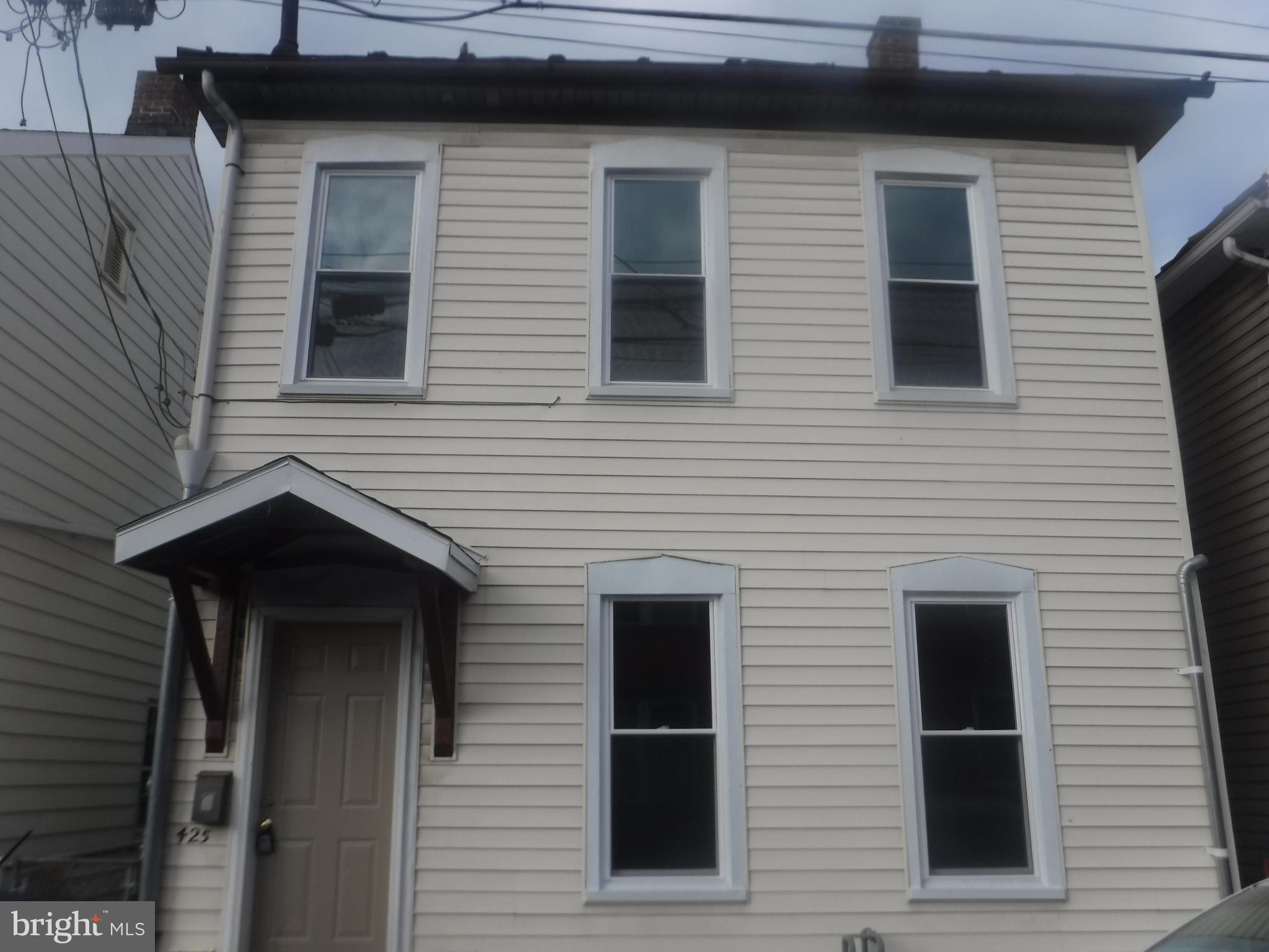 This is a large single family home that has been freshly painted, some new flooring and newer appliances. 3 large bedrooms with 2 full baths, one downstairs and one upstairs. Fenced in backyard with rear parking