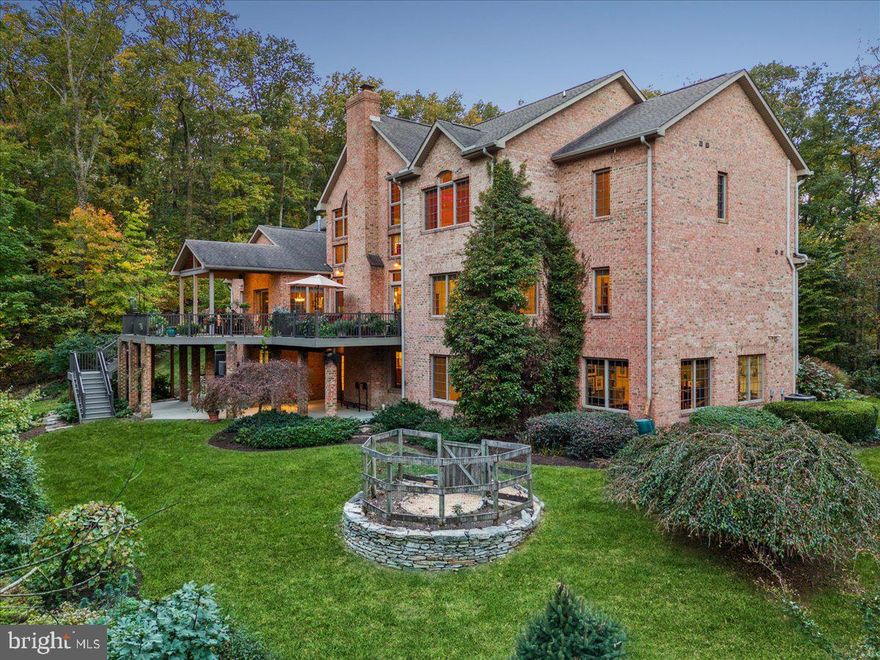 Discover your dream retreat in this one of a kind all-brick home nestled in five serene acres, surrounded by lush trees, and breathtaking rock landscapes in beautiful Braddock Heights. This exceptional property offers a perfect escape into nature right in your own backyard. This home was custom built by local Middletown builder, Greg Marsh, and thoughtfully designed by the original owners. Step inside and be greeted by a grand great room with an impressive 28 foot cathedral ceiling, creating an airy and spacious ambience, ideal for entertaining or unwinding in solitude. This room boasts a floor to ceiling stone fireplace with stones from the home site itself. The fireplace is flanked by floor to ceiling windows, creating an incredible connection with nature.  The great room leads seamlessly to the kitchen which features an eat in area, ample countertop space, and stainless steel appliances. Off the kitchen is a cozy sunroom with a gas stove and wrap around windows. Relax here with a morning coffee or evening glass of wine.  It’s one of the most special rooms in the home. The main level also features a grand primary suite with en-suite, bath, and large walk-in closet.  Not only will you notice birch hardwood floors adorning the entire main level, but you will also find additional main level features such as a large pantry, powder room, formal dining room, office/nook, laundry room, and a large mud room off the garage. The upstairs level is equally exceptional with a beautiful loft area that overlooks the great room. There are three bedrooms and two baths upstairs. The bedrooms are generously sized with two sharing a “Jack and Jill” bath, and the other having an en suite bath.  The views from the second floor are exceptional with Frederick City visible when the leaves drop. The spacious lower level has an abundance of features: an art studio equipped with sink, another home office, wet bar with additional fridge, wood stove, walk-out back patio, full bed and bath, central vacuum, and ample space for exercise and entertainment. Additional features include a large two car garage with a third garage sized for tractor and garden equipment, generous storage space in the basement, maintenance free deck with propane hook-up for your grill, four zone HVAC, incredible privacy, and much more. Whether you’re looking to explore the surrounding nature or simply to relax in your peaceful oasis, this home is perfectly situated to enjoy it all. This is an opportunity not to be missed. Embrace the ultimate lifestyle in a truly unique setting that combines elegance, comfort, and the beauty of nature. Schedule your private tour today and experience this exceptional property for yourself.