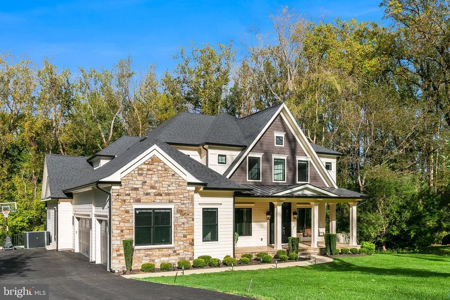 This architectural showpiece, completed in 2022, blends masterful craftsmanship with striking modern design. Set within the coveted Langley Forest community, the home is filled with natural light and refined details — created for those who value sophistication and comfort.
A welcoming foyer sets the tone with elegant formal living and dining rooms, while the breathtaking family room features a sleek fireplace and French doors that open to the expansive rear deck, which overlooks the private yard and includes a gas fire pit and a built-in gas line for grilling.
At the heart of the home is the gourmet kitchen, featuring a bold statement island topped with Silestone Quartz, custom cabinetry, designer backsplash, a farmhouse sink, and top-of-the-line appliances. A sunlit breakfast room completes this beautiful space.
On the main level, a private study with soaring 12-foot ceilings, a full guest suite, and an elegant powder room provide both function and quiet retreat.
Upstairs, the owner’s suite stuns with three custom walk-in closets and a spa-like bath with heated marble floors, dual vanities, a jetted soaking tub, and an oversized shower. Three additional ensuite bedrooms with tray ceilings and a well-appointed laundry room complete this level.
The walk-out lower level transforms into a private retreat — featuring a wet bar, expansive recreation room, fully finished media room with tiered seating, two fitness rooms, and a guest suite with full bath, kitchenette, and private entry, offering the ultimate in comfort and flexibility.
Numerous high-end upgrades were added since the home was completed in 2022, including custom fencing, an expanded driveway, a thoughtfully finished media space, and custom built-ins throughout, to name a few. Additional features include a large, flat backyard, a three-car garage with dual EV chargers, a whole-house generator, and an elevator-ready design.
Ideally located with easy access to both Reagan National and Dulles airports, and just minutes from Tysons Corner. Nearby interstates make commuting effortless, blending luxury with convenience.