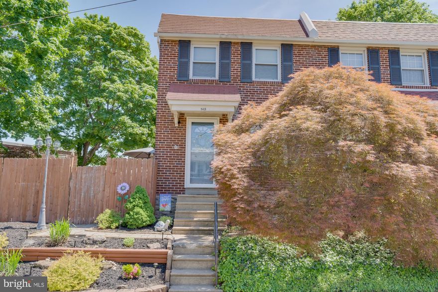 Welcome to 565 Pedley Road, a charming brick twin nestled on a quiet block in desirable Wissahickon Hills. This classic Philadelphia home offers wonderful curb appeal, with a striking Japanese Maple and garden beds that create an inviting entrance. Step inside to discover a spacious living room featuring gleaming, well-preserved hardwood floors and elegant crown molding, setting a refined yet comfortable tone throughout the home. The layout flows effortlessly into a generous dining room, ideal for entertaining, with easy access to the outdoor patio and just steps from the kitchen. The bright and functional kitchen boasts abundant hardwood cabinetry, expansive Formica countertops for prep space, a playful tile backsplash, durable vinyl tile flooring, and sleek stainless steel appliances. A side door leads to the unfinished basement and a separate laundry area, offering additional flexibility and storage.  Upstairs, you’ll find three sunlit bedrooms, each with beautiful hardwood flooring. The primary bedroom includes a spacious closet, the second bedroom features custom built-ins and a secondary closet, and the third bedroom offers a cozy nook, perfect for a reading corner or creative space. The full hallway bath features tilework and a shower/tub combo. Out back, enjoy your private, fully fenced yard—an entertainer’s dream. It includes paver patios, a grilling station, and an oversized wood deck that's perfect for al fresco dining or relaxing in warmer months.  Recent upgrades include a new water heater, central air, front door, storm door, and electrical panel (2020), plus new windows in the kitchen and bathroom and a new sliding glass door in the dining room (2024). Don’t miss this opportunity to own a lovingly maintained home in a fantastic location—schedule your showing today before it’s gone!