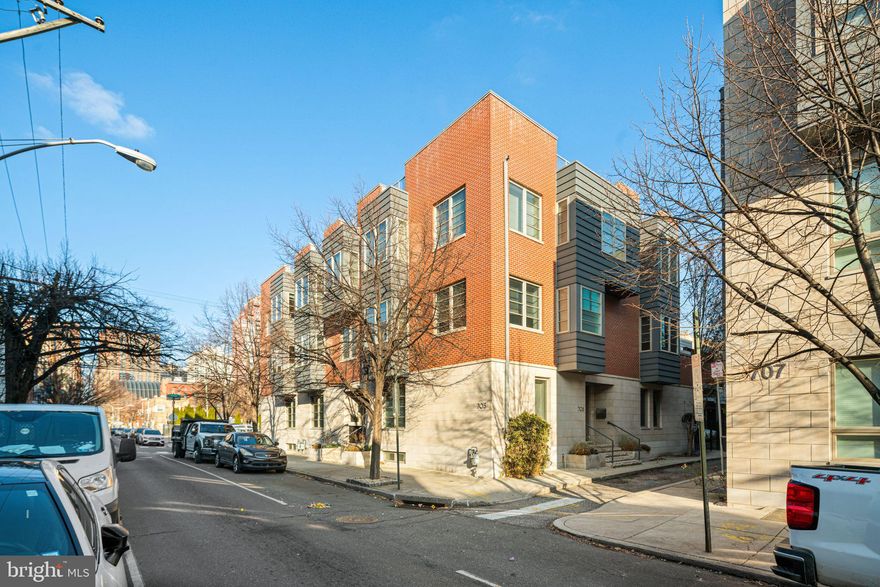 Welcome to 705 S. 15th St., a Graduate Hospital townhouse in the exclusive private gated Artisan community with secure access to a finished 2-car garage and an in-home elevator. A premium corner lot offering unimpeded views with three exposures and lots of natural light makes this exceptional residence not to be missed. Just a few blocks from Avenue of the Arts and Rittenhouse Square, this home puts the best of city living at your fingertips. Thoughtfully designed with high-end finishes, extensive custom upgrades such as window seats and built-in cabinetry, and cutting-edge technology, this home is perfect for both entertaining and everyday living. The kitchen is a chef’s dream, featuring an oversized island with a butler’s sink, custom cabinetry, a top-of-the-line SubZero fridge, three Wolf ovens, and a six-burner Wolf gas range. This floor also features an open floor plan with spacious living and dining areas, a pantry, a powder room, and an oversized patio just off the kitchen with a wood deck and a privacy wall for added seclusion. The second outdoor space is a private 126 SQ. FT. roof deck with a fire pit and city skyline views. The two oversized outdoor spaces are perfect for hosting. The primary bedroom features two custom walk-in closets and an ensuite with a steam shower. There are also two additional bedrooms with a shared bath. The ground floor office/bonus room, with a dedicated full bathroom and custom built-ins, is the perfect space to make your own. The lower level offers a spacious game room with a wet bar and two wine fridges, as well as a separate theater room with a 125-inch curved movie screen. Enjoy LED museum-style lighting throughout the house, high-end flooring that includes ebonized hardwood and porcelain tile, and a Sonos wireless system that runs throughout the house including outdoor spaces. Two separate laundry rooms—one on the lower level and one on the fourth floor—add everyday convenience. Schedule your private showing today!