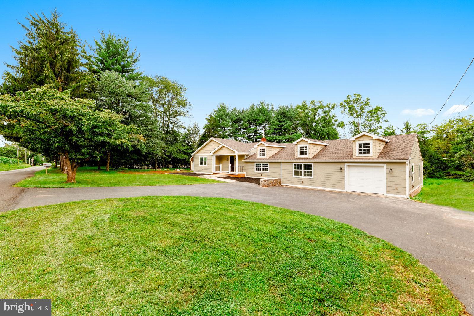 One-of-a-Kind Ranch Retreat in Bucks County! Experience natural beauty and timeless comfort at 4448 Lower Mountain Road, a fully renovated home set on 2 private acres in one of Bucks County’s most peaceful areas. Designed for effortless one-floor living, this exceptional residence is perfect for those seeking serenity without sacrificing convenience. You’ll enjoy proximity to charming town centers, premier golf courses, and major routes (413, 202, 232) with easy access to Philadelphia, New York, and New Jersey, all within the Blue-Ribbon Central Bucks School District. Step inside the bright, welcoming foyer and discover a thoughtfully reimagined interior blending modern finishes with timeless character. The main level features three well-appointed bedrooms and 2.5 bathrooms, including a luxurious primary suite with a spa-like bathroom featuring a jetted soaking tub, glass-enclosed stall shower, dual sinks and private deck access for peaceful moments. The gourmet kitchen is a true showpiece with abundant storage, two refrigerators, an oversized island with statement countertops, stainless steel appliances, pot filler, wine refrigerator, and a butler’s pantry. Designed with both form and function in mind, this space is perfect for everyday living or entertaining on a grand scale. The living room, surrounded by windows, bathes in natural light and offers an inviting space to relax or gather with guests. Just beyond, the family room features soaring ceilings, a dramatic exposed beam, and warm oak flooring, creating a spacious, comfortable environment with a seamless flow outdoors. An adjacent bonus room provides flexible options for a home office, gym, or guest bedroom. From the family room, step onto a large deck overlooking tranquil wooded views the perfect backdrop for morning coffee or evening entertainment. The expansive yard offers endless possibilities: host summer gatherings or create a cozy firepit retreat for nights under the stars. Added details include attached 1 car garage, detached storage shed, sleek two-panel doors, designer lighting, stylish tilework, and exposed wood accents. With all-new HVAC, electrical, windows, roof, siding, and plumbing systems, this home is truly move-in ready with peace of mind. Don’t miss this rare opportunity to own a fully renovated ranch on 2 private acres in Bucks County, where timeless comfort meets modern design.
