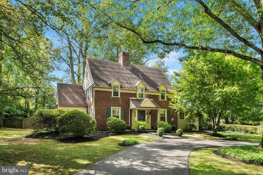 Just four blocks from downtown Wayne, this classic brick colonial is nestled on a sprawling corner lot in one of the Main Line’s most coveted historic neighborhoods. From the bucolic, tree-lined street, a circular driveway and professionally landscaped front yard create a delightful first impression. Step inside to a spacious, freshly painted main level with refinished hardwood floors, designer lighting and artisan millwork. Off the foyer sits a sun-drenched living room anchored by a wood-burning fireplace and custom built-ins framing a charming window seat. Just beyond, the cheery eat-in kitchen boasts new countertops, a dedicated workstation, gas cooking and abundant cabinetry. The adjoining breakfast room steps down to an inviting family room with custom built-ins and tri-panel glass door to the rear terrace and lush greenspace. Tucked away on the other side of the main level, a cozy study with bay window and custom cabinetry is ideal for work-from-home lifestyles. Other main floor highlights include a mudroom with cubbies and pantry closet, updated powder room and bright front dining room. Upstairs discover a primary suite with renovated dressing area boasting a freestanding soaking tub, marble floors and walk-in closet. An updated guest suite with marble ensuite full bath (and convenient stairway to the kitchen), plus two additional bedrooms and a full hall bath complete this seamless second floor. The finished lower level offers additional entertaining and play space accented by stylish wainscoting and updated flooring. Out back, your park-like oasis awaits complete with stone terrace, manicured gardens and flat greenspace bordered by mature trees for privacy. Enjoy all this amid the warmth and charm of the walk-to-Wayne community and its beloved shops, restaurants, festivals, parks, award-winning schools and playgrounds. Don’t delay; make this classic colonial your forever home today! All offers are due by 2pm Monday, October 13th.