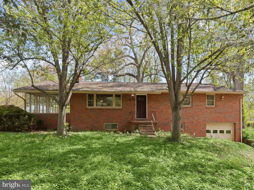Nestled on nearly half an acre in sought-after Howard County, this all-brick rancher presents a rare renovation opportunity with incredible potential. Boasting over 2,800 square feet of space, the home offers room to grow, personalize, and make your own. Step inside to discover a spacious living room with a large picture window. Hardwood floors flow through most of the main level, leading into the dining room situated just off the kitchen and living room for easy gathering. Three bedrooms and two full baths on the main level include a primary suite with its own private bath. An expansive enclosed porch extends the living space with endless possibilities, whether as a sunroom, playroom, or future studio overlooking the backyard. Downstairs, the finished lower level opens to a large family room centered around a wood-burning fireplace. Two additional bedrooms, one with an attached full bath, offer great potential for an in-law or guest suite. A utility room with walk-up stairs adds convenience, connecting directly to the spacious, tree-lined backyard. Outdoors, the property is framed by mature trees and includes a storage shed for tools and equipment. An oversized one-car garage offers plenty of additional storage or workspace for hobbies and projects. Centrally located with quick access to US-29, I-95, and MD-32, this home puts you just minutes from shopping, dining, and major commuter routes. Whether you're ready to renovate, invest, or simply need space to spread out, this classic rancher is bursting with potential.