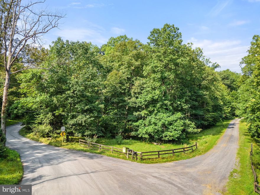 Thinking about building but need the perfect spot, look no further than this little piece of heaven.  12 acres located in a small subdivision where the homeowners work together to maintain the private gravel road. There are covenants but no HOA has been established. This unique lot features sloping terrain with a nice flat building area, two springs run through the property with the potential for a pond and you will even find a wonderful rock cliff on one side of the lot giving a natural buffer to Oregon Hollow Rd. This lot is convenient yet secluded with easy access to shopping,  Shenandoah National Park, Appalachian Trail, and the many local vineyards and breweries. Located just minutes from  commuter routes like Rt. 66 and I-81  this is the perfect piece of ground to build your dream home or mountain retreat. The driveway has already been installed and a septic certification letter puts you steps closer to building your new home.