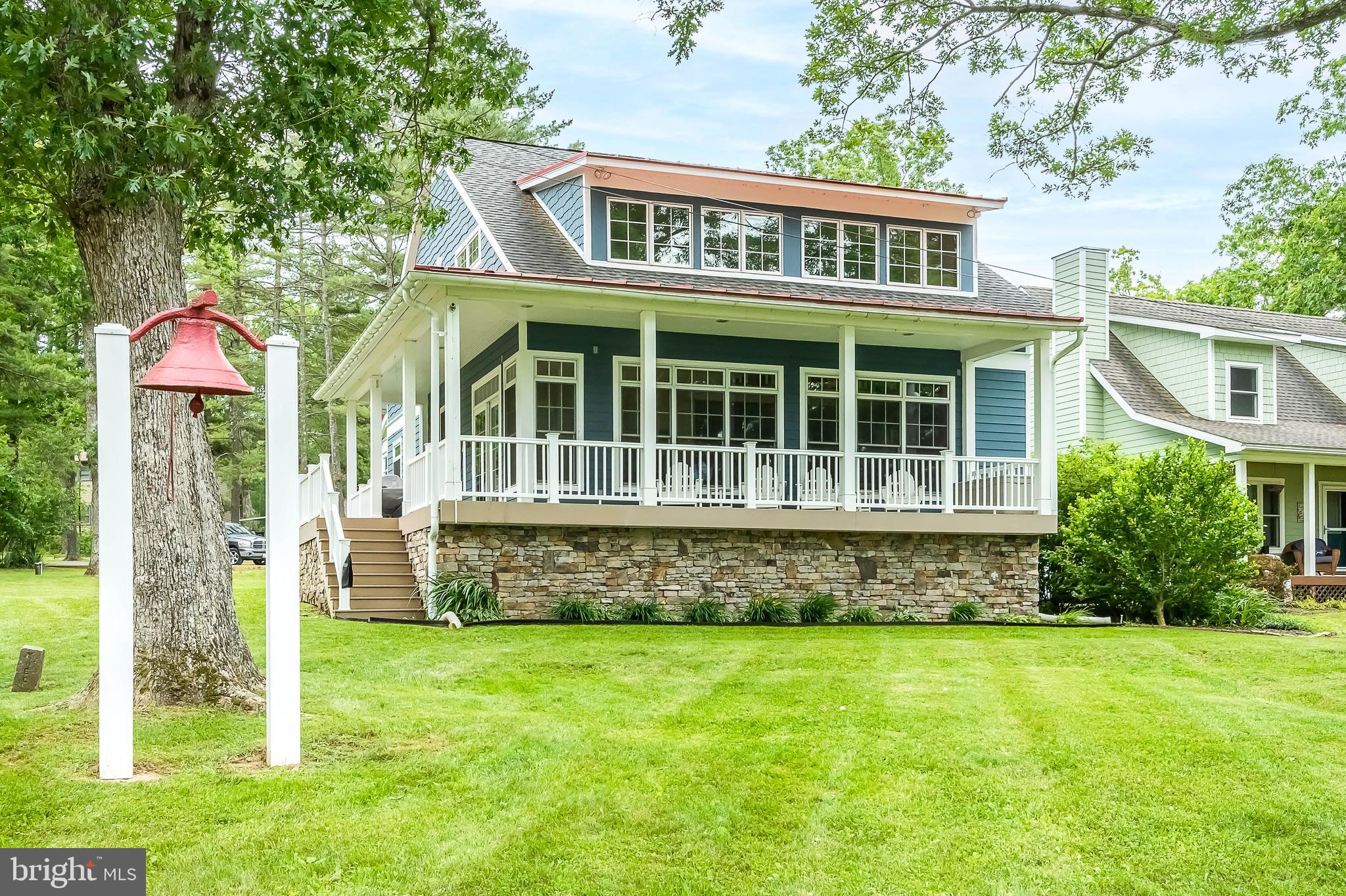 Charming lakefront cottage in a quiet cove on an open, premium site. This home is warm and inviting from the moment you enter. Offering a stone gas burning fireplace, hardwood flooring, granite countertops, vaulted ceilings, and a great loft area. The abundance of windows allows you to enjoy the beauty of Deep Creek Lake during all seasons. The covered porch is just one more great feature, offering plenty of space to enjoy with family and friends. If all of this isn't enough, right outside, you also can enjoy a nice firepit, hot tub, and your private Type A dock. This turn-key home truly checks off all the boxes. Established vacation rental "Sunset Cove". Call today to preview this gem, it won't last long!