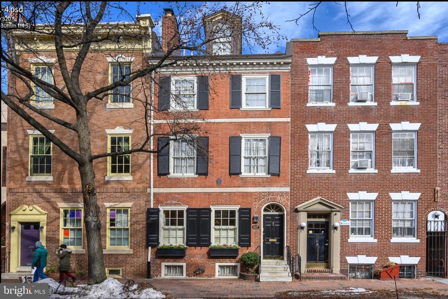 The Edward Shippen Burd House (c. 1805-1807). This elegant and spacious historically registered Federal home has been meticulously restored with every modern amenity. Situated in the finest location of historic Society Hill, this impeccable home begins with the original marble steps that enter into a stunning formal vestibule with a glass etched lighting fixture, in-laid tile and crown molding leading into the formal living room and dining room. This breathtaking area is spacious with 10 foot ceilings that highlight its character and history. Gleaming hardwood floors and custom millwork are throughout the home. The functioning wood burning fireplace has an antique mantle (c. 1901) and marble surround. The granite counter bar in the dining room has a pass through with custom leaded pocket windows leading into the kitchen. The gourmet kitchen has a stunning glass roof, polished granite countertops, custom tile backsplash, dual stainless steel sink, insta hot water dispenser, Bosch dishwasher, Sub-Zero refrigerator, radiant heat under the tile floors, Wolf 5 burner cooktop, Wolf oven and warming drawer and custom 42 inch cabinets with nickel hardware encompassing every inch of the kitchen. The first floor bathroom has artistic hand painted walls and ebony marble floors with contrasting white gray vein marble counter sink. The lower level is designed for casual entertaining and features a climate controlled 1000 bottle wine cellar with etched glass custom door, 16th century inspired Italian fresco, working gas fireplace, exposed brick wall, custom entertainment center and antique Belgium bar back (c. 1885) and the bar made from English Oak (c. 1880). The master suite located on the entire second floor features a spacious bath with double vanities, extravagant marble and glass shower, marble floors and bidet. The master bedroom has a working fireplace mantle (c. 1880) and an enormous walk in closet with built in shelving and cabinetry. The 3rd floor is complete with two additional bedrooms, spacious closets and a full bath with Jacuzzi. The 4th floor bedroom has the original exposed attic beams and is currently used as an office. The professional size Maytag washer and dryer and Bosch tankless water heater are installed in a double door easy access closet. The perimeter of the room has an incredible amount of storage. The roof deck offers stunning panoramic views of the city and is equipped with lighting and plumbing. The home features custom historic windows and window treatments throughout; ceiling speakers wired on the lower level, 1st level and 2nd level; and two zone heating and air conditioning. This magnificent location is convenient to center city, historical sites, parks, waterfront, many restaurants, theaters, shopping, movie theaters, minutes to the airport and access to all major interstates. Includes 1 year pre-paid covered garage parking at 7th and Delancey St