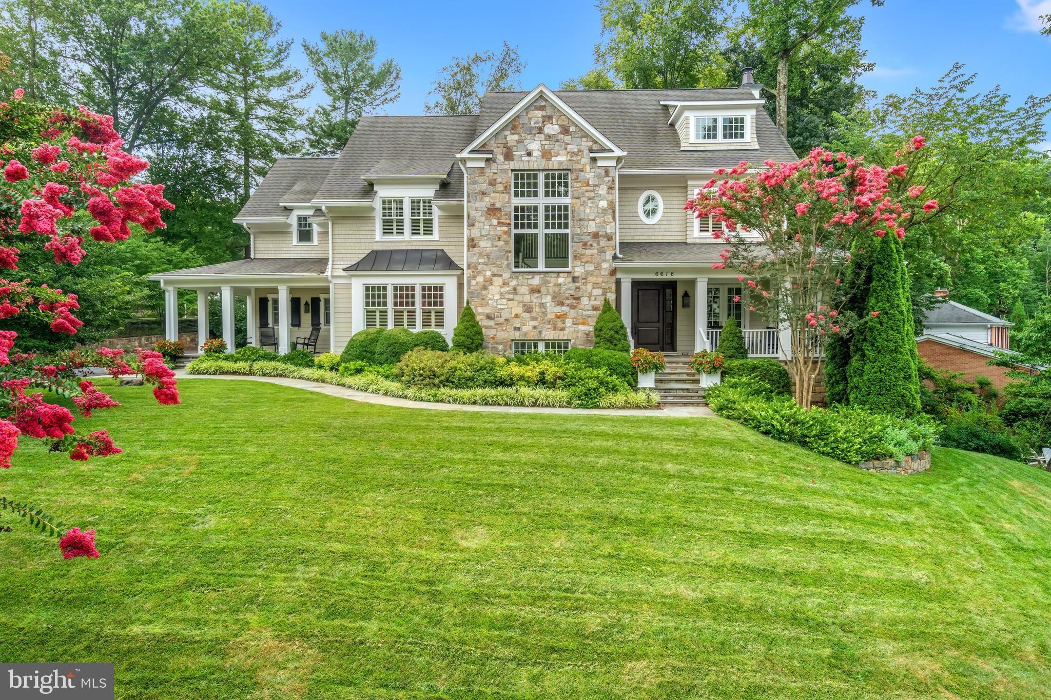 Outstanding Solid, Masterfully Built with high ceilings throughout and 2 staircases - Welcome to 6616 Lybrook Court, an extraordinary quality residence built by premier custom home builder Sandy Spring Builders and designed by GTM Architects. Nestled in the exclusive and highly desirable Burning Tree neighborhood, this meticulously maintained home sits on a beautifully landscaped nearly half-acre lot (0.42 acres) and offers over 7,800 square feet of luxurious living space across three finished levels. Flooded with natural light, every space in this home feels bright and inviting.
Built in 2012, this stunning home features five bedrooms, five full baths, and two half baths, along with an oversized side-load three-car garage and a spacious, flat driveway. Thoughtfully designed with custom high-end finishes throughout, it boasts soaring 10’ and 9’ ceilings, elegant moldings, rich hardwood floors, coffered ceilings, energy-efficient Low-E windows, and the convenience of both front and back staircases for seamless flow between levels.
The main level impresses with an inviting foyer featuring a dramatic two-story staircase with expansive windows that flood the space with natural light. To the right, a handsome library with built-ins offers access to the charming covered front porch, while the formal dining room on the opposite side enjoys access to a separate covered porch, creating a seamless indoor-outdoor flow. A guest powder room is conveniently located just off the foyer.
The heart of the home is the gourmet chef’s kitchen, featuring honed granite countertops, an expansive Carrera marble island, and top-of-the-line stainless steel appliances, including a Sub-Zero refrigerator, a Wolf gas range, Wolf double wall ovens, and a Bosch dishwasher. A large pantry provides plentiful storage, while a butler’s pantry with custom cabinetry and a beverage refrigerator connects the kitchen to the dining room for effortless entertaining. The kitchen seamlessly opens to a sunlit breakfast room and a spacious family room, complete with an impressive, coffered ceiling, built-ins, a gas fireplace, and access to the rear slate terrace.
An oversized, well-appointed mudroom serves as a functional hub of the home, offering abundant storage, custom-built cubbies, large closets, and direct access from both the side-entry covered porch and the three- car garage garage. This space also includes one of the two main-level powder rooms, ensuring convenience for everyday living.
Upstairs, the luxurious primary suite boasts two generous walk-in closets with custom built-ins, a spa-like bath with heated floors, a free-standing soaking tub, a shower room, dual vanities, and a private toilet closet. Three additional bedrooms, each with en-suite baths, provide exceptional comfort. A versatile bonus sitting room with built-in workspaces and a spacious laundry room with ample counter space and cabinetry complete this level.
The walkout lower level is an entertainer’s dream, featuring almost 10 foot ceilings, a large recreation room with a gas fireplace, a bedroom with a walk-in closet and full bath, an exercise/media room, and three additional storage rooms. Brand-new carpeting enhances the space, and front and back staircases ensure easy access to all levels.
The large lot actually extends well beyond the privacy trees. Please see site plan. You could easily expand the backyard to create more usable space or add a new privacy fence farther back behind the privacy trees, especially if you are considering a pool or other outdoor features.
Set in an exclusive neighborhood known for its stunning architecture and peaceful surroundings, this home is beautifully landscaped with lush greenery and a spacious, flat driveway. Enjoy the convenience of easy access to downtown Bethesda and major commuting routes while cherishing the charm and privacy of this extraordinary property. A rare opportunity—don’t miss it!