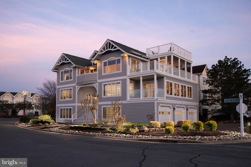 ELEVATED DESIGN MEETS THE DELAWARE BAY! This spectacular 7-bedroom, 4.5-bath bay block coastal retreat in the coveted Cape Shores community delivers 3 levels of beautifully designed living space, jaw-dropping bay views, and the kind of turnkey luxury that commands top-tier vacation rental income season after season.
From the moment you arrive, the architecture impresses with a striking three-story coastal craftsman with multiple decks, a screened porch, and a crowning rooftop observation deck where panoramic Delaware Bay views stretch as far as the eye can see. Whether you're watching the sunrise with coffee or the sunset with cocktails, this perch is nothing short of breathtaking.

Inside, the open-concept main living area is bathed in natural light beneath soaring vaulted ceilings with skylights. The designer kitchen is a true showpiece: white shaker cabinetry with brass hardware, quartz countertops, a navy island, subway tile backsplash, built-in wine fridge, and a professional Wolf 8-burner range and oven that will delight any chef. The dining area flows seamlessly from the kitchen, anchored by a statement beaded chandelier and floor-to-ceiling windows framing the bay beyond. The great room is equally impressive: vaulted, light-filled, and styled with a coastal sophistication that photographs beautifully.

The screened porch off the top level offers al fresco dining with ceiling fan and sweeping water views, while the rooftop deck with Adirondack seating is the undisputed crown jewel of this property.
Seven generously sized bedrooms provide ample sleeping capacity for large groups, making this an exceptional income-producing asset in one of the Cape Region's most desirable communities. Cape Shores residents enjoy access to a community pier, private beach, outdoor pool, tennis courts, and community center -  amenities that keep guests coming back year after year.
Perfectly situated adjacent to Cape Henlopen State Park with miles of pristine beaches, hiking and biking trails, and fishing and just a short bike ride or drive to the charming boutiques, restaurants, and rich maritime history of historic downtown Lewes. Rehoboth Beach is only minutes away, adding even more to an already unbeatable location.
This is Delaware beach living at its absolute finest, and now is the time to make it yours!