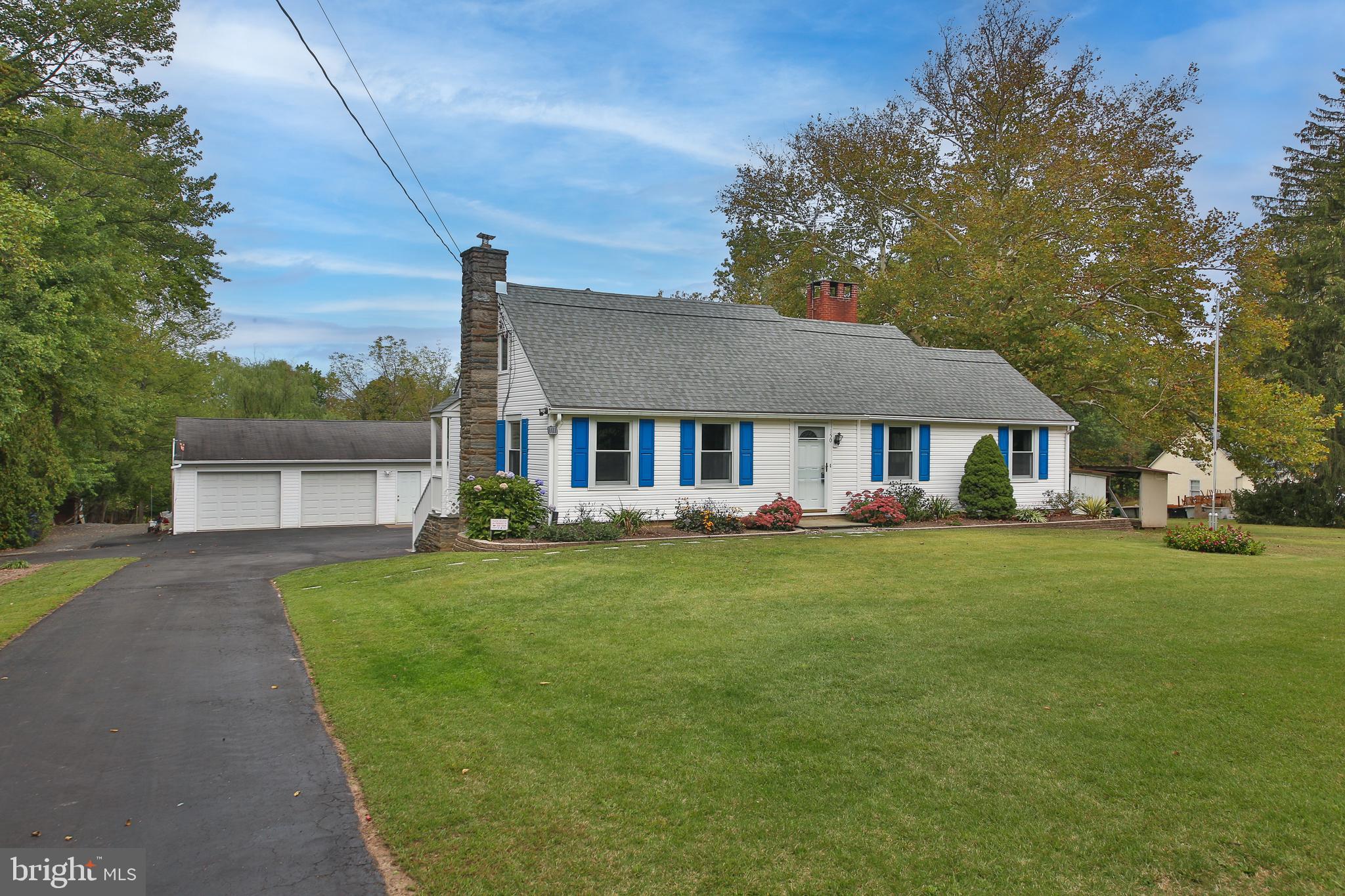 Classic Doylestown Township. This timeless home in the iconic Cape Cod style, brimming with curb appeal and character, is a special find for those searching for expansive acreage and versatile, outdoor utility space…ideal for homebuyers that want privacy and additional vehicle or equipment storage space--all for an exceptional value! Set on 2.28 acres, the picturesque lot offers both wide, open space and serene treed privacy. In addition to the detached 2 1/2 bay car garage, there is a 21 x 24’ metal utility building which could be used for workshop space, or recreational/equipment gear. This lovingly and well-maintained, second owner home has all the charming features that are rare to find, but often sought after; hardwood flooring, plaster walls, rustic, wood paneled ceiling and beams. In addition, the major systems and structural elements have been replaced: with Pella windows, newer roof, leaf filter gutter guards, vinyl siding, retractable patio awning, newer furnace, water heater, and central air. Also, special features found in this warm and welcoming home include, first floor bedroom/office with full hall bath, an expansive, sunlit living room with open hearth brick & slate fireplace with wood stove, and a primary bedroom with sitting room and adjacent 2nd floor veranda, overlooking a peaceful view of nature, plus a rear patio--both offering you an opportunity to unwind and enjoy the fresh air, day or evening. The partially-finished basement adds to your recreational living and entertaining spaces with plumbing in place to add an additional bathroom if desired. With incredibly low taxes, move-in ready systems and ample room for future additions or customizations to this solid-built home, this home presents the unmatched opportunity you have been waiting for. Don’t delay, schedule your appointment today!