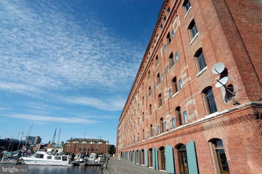 Tastefully renovated 2 story 1 BD 1.5 bath loft style Henderson's Wharf condo w/marina view on cobble stone street.  Exposed brick walls w/stainless steel appliances, granite built-in table and counter tops and extra cabinetry.  Real hardwood floors on first level and half bath.  Master bedroom with w/ 2 large closets and renovated master bath.  One deeded, same floor indoor garage space.