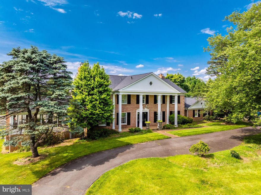 This property is a spectacular bucolic 8.43 acre equestrian property  located just off Georgetown Pike near the Village of Great Falls. The privacy and tranquility of this property cannot be beat. Located at the end of a country lane winding past beautiful estates and mature trees framing the road. The stately traditional brick colonial with a circular drive and four car detached garage with an attic  is handsomely sited at the entrance of the property. The property includes a full service guest house, 6 stall barn, two run in sheds, 4 paddocks, a lighted riding ring with gravel walkway from the barn and thoughtfully fenced and crossed fenced. The house feels like a country home with wide-planked wood flooring and trim throughout, four wood burning fireplaces in the main living areas and a gas fireplace in the primary suite. The owner's suite has a luxury bath and large custom walk-in closet with a second laundry nook containing a stacked washer and dryer. In addition to the primary suite, there are two en suites with updated baths. One of the highlights on the main level is a huge family room with a cathedral ceiling, walls of windows, custom wood paneling and a wood burning fireplace. The formal living room has custom wide plank tongue & groove heart of pine flooring and solid cherry beams with a stone-faced wood burning fireplace and French doors to a large screened porch. The formal dining room also has a wood burning fireplace and custom wood flooring and high end wallpaper. At the other end of the main level, there is an expansive great room with a hand-stacked stone fireplace, wet bar and custom cabinetry on three walls. The main level is complete with an updated kitchen and adjoining breakfast nook, cozy library, two half baths and a mudroom/laundry room with doors to the front and backyards. The walkout lower level is ready for the new owners to finish for their lifestyle. There are scenic views from every window on the main and upper levels. Outside the house there are brick walkways to the barn, a fire pit and a tree fort. The guest house features a two story family room with brick fireplace, eat-in kitchen, full bath and lofted bedroom. This space is perfect to rent or Airbnb, offer to guests for added privacy or provide a barn manager for on site accommodations. The center-isle barn includes 6 generous stalls with water, a wash stall, feed room, a hay loft, and environmentally controlled tack room with sink. The barn is well lit and has been in continuous use and is full operational.