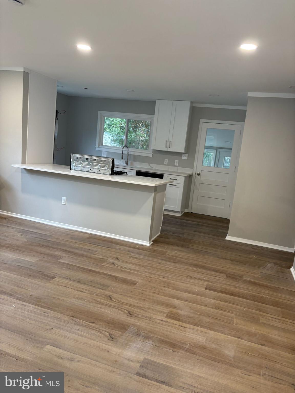 Completely Renovated One Level Home, 3 Bedrooms, 2 Baths, bright Sun Porch overlooking Large Back Yard. New windows, Beautiful Laminate Wood Floors, New Appliances, New Bathrooms with Ceramic Tile. New kitchen cabinets and countertops, New lighting and paint. Move in ready!! Walk to Shopping Mall, close to Route 198 and Route 1. Quiet Neighborhood.