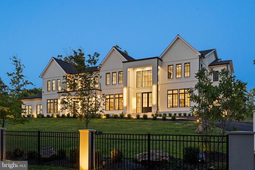 Welcome to this extraordinary 1.35-acre estate, where timeless sophistication and modern luxury converge. Envision arriving at your exquisite new home—a true architectural marvel spanning 10,175 sq. ft. of luxurious above-grade living space, with an additional 5,018 sq. ft. below grade. Constructed in 2023, this residence is a meticulously crafted masterpiece of refined elegance, offering some of the finest features and finishes in McLean.

As you enter, a grand two-story foyer with 12-foot ceilings on the main level welcomes you, setting the tone for the spacious, airy ambiance carried through the entire home. The upper and lower levels boast 10-foot ceilings, enhancing the feeling of openness and light. Throughout, large windows capture beautiful views of the surrounding grounds.

This six-bedroom residence features eight full baths and three half baths, along with a grand paved driveway leading to a four-car garage. You’ll find four stunning gas fireplaces with granite surrounds, dramatic tray ceilings, and a wealth of amenities for entertainment and relaxation. Each bedroom is thoughtfully designed with a walk-in closet and an ensuite bathroom. Outside, a luxurious stone patio surrounds an inground pool with an automatic cover, creating a tranquil space for relaxation.

The main kitchen is a chef’s dream, showcasing Cambria Quartz counters, Belmont cabinetry, and a substantial center island. Premium Miele appliances include a 36" refrigerator and freezer, double oven, 24" built-in coffee system with smart touch control, microwave, dishwasher, 48" gas cooktop, wall-mount range, and a double-door wine/beverage cooler. A second kitchen, outfitted with Bosch appliances, offers additional convenience with a 36" refrigerator/freezer, electric range, dishwasher, and built-in microwave.

Adjacent to the kitchen, you’ll find a bedroom with a full bath, a laundry room with an LG ThinQ washer and dryer, and a mudroom that connects to the garage. The main level also hosts an expansive family room with a fireplace, a formal living room with another fireplace, a dining room, an office, and two powder rooms. Oversized windows flood the space with natural light and provide stunning views.

On the upper level, the primary suite is a luxurious retreat featuring a private balcony overlooking the pool, a sitting area with a double-sided fireplace, a custom closet with a center island, a spacious walk-in shower, and an oversized ensuite bathroom. Three additional well-sized bedrooms, each with ensuite bathrooms and walk-in closets, plus a second laundry room with LG ThinQ appliances, complete the upper level.

For entertaining, the main-floor bar includes a Zephyr beverage cooler, KitchenAid under-counter drawer refrigerator and freezer, and Fisher & Paykel drawer dishwasher. The basement level offers a modern wine room, a full bar with leathered granite counters, a Brisas double-door beverage cooler, Bosch dishwasher, and Samsung refrigerator/freezer—making it ideal for hosting gatherings.

The expansive downstairs area also includes a recreation room, state-of-the-art theater, covered patio overlooking the pool, gym, spa with a sauna and steam room, a bedroom with ensuite bath, additional laundry and utility rooms, and two half baths.

This home’s intelligent design is equipped with an elevator by the Residential Elevator Company, providing access to all levels. UV-blocking window films, a comprehensive smart system controlling climate, security, and entertainment, and electric blinds in the primary bedroom and main floor add comfort and convenience. The property is powered by a 24KW Generac generator, with a five-zone Infinity HVAC system and Infinity smart thermostats providing high-efficiency climate control.

This estate is more than a home; it’s an experience, a statement of elegance, and an unrivaled opportunity to live your best life in the heart of McLean.