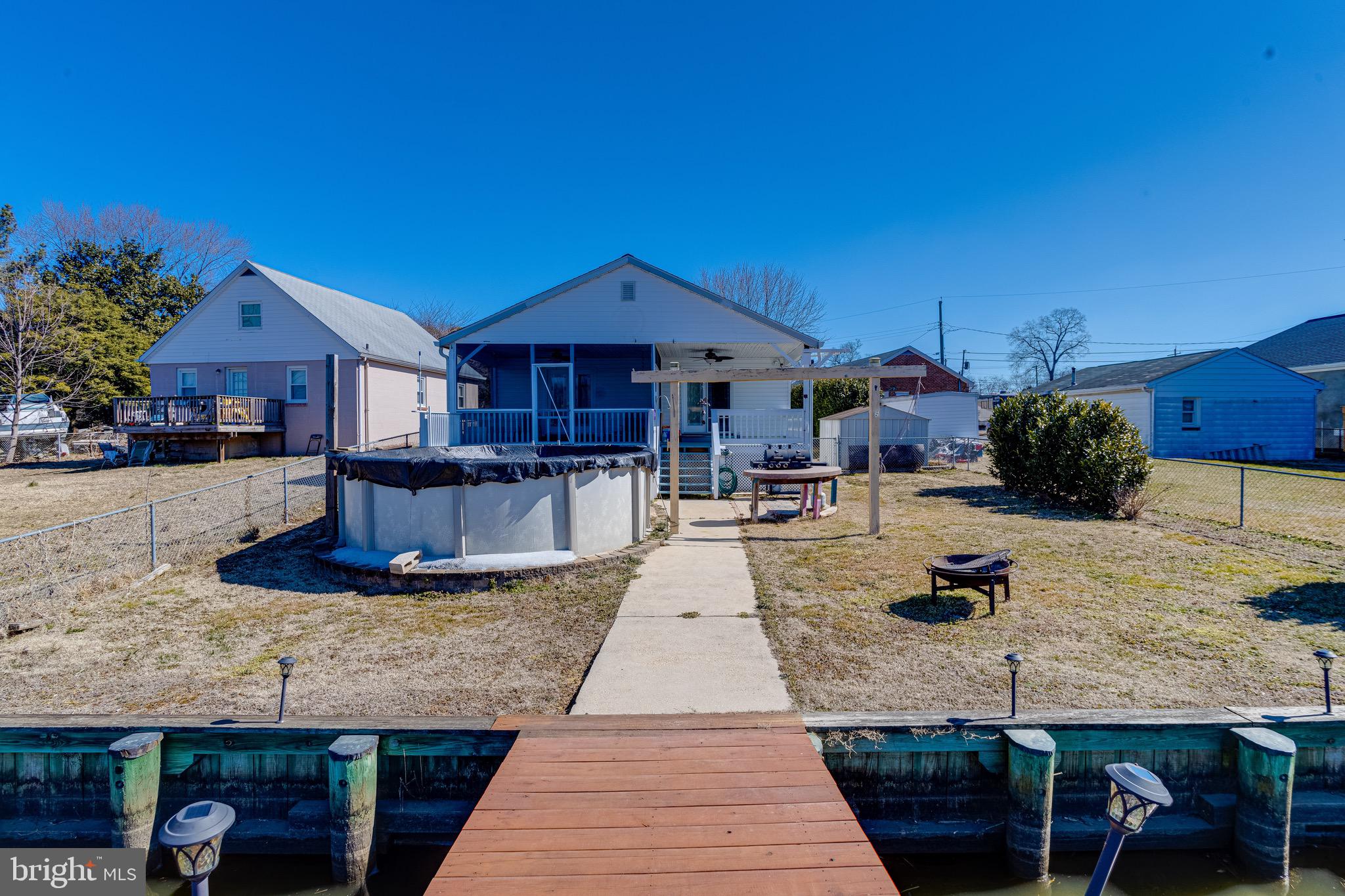 Live the waterfront dream at 808 Creek Rd in Essex! This charming 2 bed, 2 bath updated home offers the perfect blend of comfort and coastal living. Imagine waking up to serene water views from your choice of two covered decks, including a screened-in porch ideal for enjoying evenings by the water. The updated kitchen features granite counters and a stylish island, while modern wood flooring enhances the home's contemporary feel. Boating enthusiasts will love the private pier with a boat lift, and the above-ground pool provides endless summer fun. Don't miss this opportunity to create lasting memories in your own waterfront bungalow.