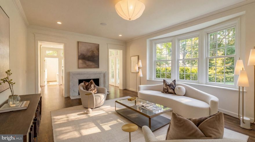 Gracefully set on a beautiful parcel in the heart of coveted Massachusetts Avenue Heights, 2825 McGill Terrace NW is a classic 1929 home reimagined with sumptuous contemporary elegance, all while honoring its timeless ethos. A visionary masterpiece by Kent Construction & Development, this residence is the result of a meticulous collaboration with acclaimed interior designer Zoe Feldman and renowned landscape architect Joseph Richardson. Together, they have left no detail untouched in crafting one of Washington’s most distinguished luxury homes.
 
A thoughtfully designed entry reveals the rejuvenated historic brick façade, now finished in a light, refined hue and accented by new Andersen windows. A slate and copper roof adds stately contrast, while an attached two-car garage is discreetly tucked away. A flagstone walkway offers a suitably regal welcome to the foyer. Inside, original parquet floors and a formal powder room with a freestanding Italian marble vanity introduce the floor plan, which spans over 5,000 square feet across four levels of refined living. Finishes from Baldwin, Restoration Hardware, Forbes & Lomax, Waterworks, and Rejuvenation speak to the no-expenses-spared approach throughout.
 
Step down into the formal living room, a nearly 26-foot-long, embassy-sized space featuring dark walnut-stained oak floors, a custom Italian marble fireplace, and elaborate crown molding. A Sonos sound system envelops the main level, perfect for entertaining. The adjacent dining room is bathed in natural light from two walls of glass and connects seamlessly to the kitchen via a serene breakfast room.
 
At the heart of the informal spaces lies the chef’s kitchen, an architectural statement anchored by a custom arched hood lined with imported Australian clay tiles. Custom inset cabinetry, unlacquered brass hardware, unbroken slabs of Taj Mahal quartzite, a walnut island topped in black soapstone, and top-tier appliances from Sub-Zero, Wolf, and Miele define the space’s exquisite functionality. The adjoining family room features custom built-ins and an L-shaped bar with Brazilian quartzite countertops, perfect for relaxed gatherings.
 
The main staircase leads to a central upper-level vestibule. The primary suite occupies its own wing, with a private IPE balcony and two custom walk-in closets. Outfitted with a dedicated Sonos zone, the suite offers a serene, fully integrated retreat. Inspired by the world’s finest spas, the bath showcases bold Moroccan hand-made Zellige tile, Waterworks fixtures, a floating tub, dual vanities, and a walk-in glass shower with two large rain shower heads and body spray. Two additional ensuite bedrooms and a laundry room complete this level. The expansive top floor offers a full bath, a cedar closet, and two additional bedrooms – ideal for guest space, an office, or a yoga studio.
 
Downstairs, the nearly 48-foot-long recreation room creates a generous space for entertaining or lounging. A powder room, second laundry, and gym occupy one end, while a soapstone bar and glass-enclosed wine room with adjacent open wine lounge elevate the opposite side. Behind the scenes, smart systems include Nest thermostats for three new efficient, gas-fired Carrier HVAC systems, a new 80-gallon electric water heater, and a comprehensive ADT security system with security cameras throughout. Fenced and shaded by a lush canopy, the private grounds complete this extraordinary offering.
 
Rich in history, reimagined with precision, and elevated to modern luxury’s highest standard, 2825 McGill Terrace NW stands peerless among Washington’s most exceptional homes.