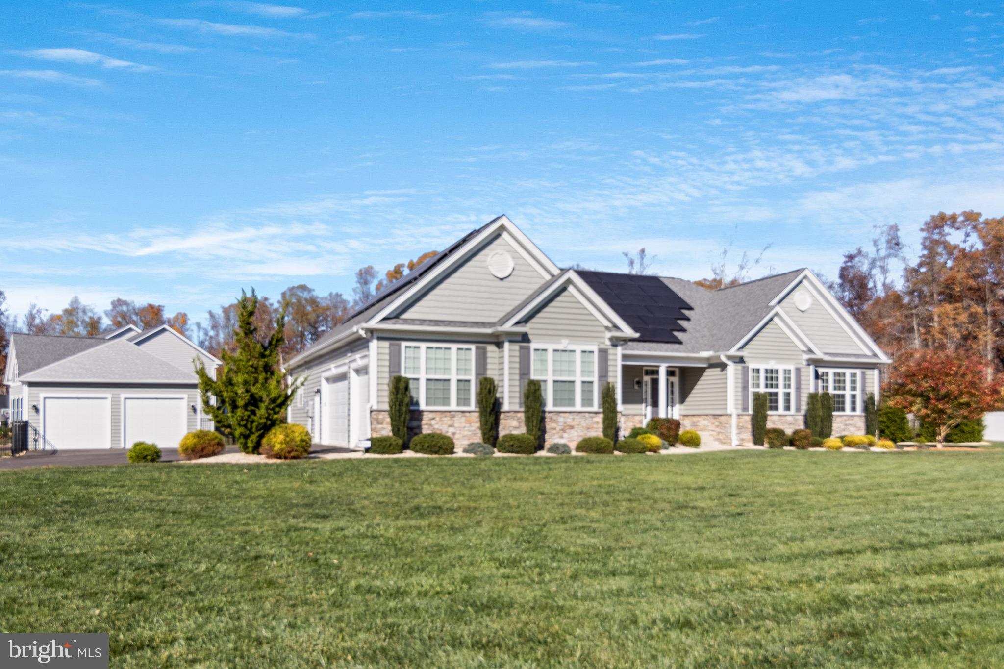 Like new construction but without the wait!! **Pre-approval letter required prior to showing. ** Shows like a model home! Built in 2019 by Quality Built Homes, this meticulously maintained 4-bedroom, 3.5-bath Winchester model features a VA assumable loan at an impressive 2.2%. From the moment you arrive, you’re greeted by custom-lit stone pillars and lush landscaping, maintained by an efficient 15-zone irrigation system. The exterior combines CertainTeed Carolina Beaded siding in sea grass, tuxedo grey shutters, white corner accents, and complemented by architectural roof shingles with 5-inch gutters for added durability. A large front porch with columns invites you in through an elegant entry, framed by sidelights and a transom window that fills the foyer with natural light. Inside, the open floor plan showcases soaring 9-foot ceilings on both levels, creating a sense of spaciousness. Beautiful hardwood floors flow throughout the foyer, kitchen, office, and bedrooms. At the heart of the home is a gourmet kitchen featuring leathered granite countertops, a touch-control induction cooktop with a pot filler, dishwasher, a built-in oven and microwave, under-cabinet lighting and a large walk-in pantry. The expansive island is complete with outlets and ample storage. Retreat to the owner’s suite that features an angled tray ceiling, then step into a spa-inspired bathroom, deluxe tiled shower, soaking tub, and tall double vanities with granite countertops. Smart home technology allows for remote control and monitoring of essential systems. The very energy-efficient solar panels, which are transferrable, virtually eliminates your SMECO bill! An Eco Flow smart panel is also part of the home. The expandable irrigation system comes with Wi-Fi capabilities, allowing for remote management from any mobile device. Downstairs, discover a recreation room and a full bath, along with a spacious unfinished area awaiting your personal touch. The water-softening system is conveniently located here and a state-of-the-art security system with hard-wired cameras ensures peace of mind without monthly fees. Step outside to a screened-in porch with Trex decking, a dual-temperature swim spa, and beautifully landscaped, low-maintenance backyard with landscape lighting to highlight the property, The 3-car side load garage and 2-car detached garage, feature EV charging connections. This home is in an ideal location if you need quick access to DC or points beyond but close to all local amenities. Schedule your private tour today! Make this exquisite home yours and start living the lifestyle you’ve always envisioned.