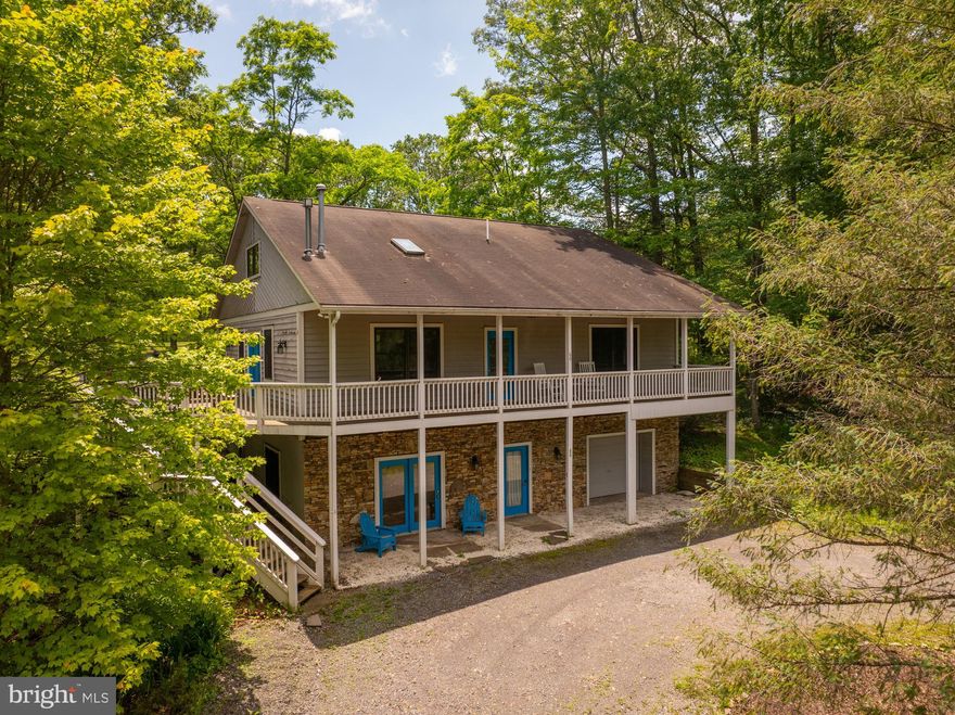 This is the mountain retreat you've been waiting for! Perfectly positioned along the scenic 17th fairway of Fantasy Valley Golf Course and just a short walk to the slopes of Wisp Resort, 60 Barbara's Way offers the ultimate four-season lifestyle. With serene pond views this charming lodge immediately welcomes you with its circular driveway and rustic curb appeal. Inside, the open floor plan features cathedral ceilings, a grand stacked-stone fireplace, and a spacious kitchen with a large island and oversized dining area—ideal for entertaining. Step out to the covered back porch for peaceful golf course views or soak those sore muscles in the hot tub. Enjoy cozy nights in one of three separate living spaces, including an expansive loft and a lower-level family room with a second fireplace. The primary suite boasts a luxurious soaking tub, and the attached garage offers generous storage/game room. Whether you're skiing, golfing, or relaxing, this location can’t be beat—just minutes from Deep Creek Lake’s top attractions. Schedule your private showing today!