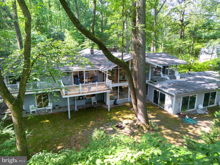 Private, Peaceful, and Perfectly Positioned- Indoor Pool Is Opened

Welcome to 310 Jeffrey Lane—Rumored to be a McElroy House, this beautifully updated ranch-style home is tucked away on a serene cul-de-sac in the coveted Greene Countrie neighborhood of Newtown Square. Set on 1.23 private, wooded acres backing to protected open space, this residence offers the rare blend of modern comfort, natural beauty, and total privacy.

Inside, you're greeted by soaring vaulted ceilings, oversized windows, and hardwood floors that create a warm and airy ambiance. The open-concept living and dining areas are anchored by a striking stone fireplace and flow seamlessly onto a large deck—perfect for entertaining or enjoying your morning coffee surrounded by nature.

The thoughtfully designed layout includes a spacious primary suite tucked privately on one side of the home, complete with a walk-in closet, an updated en-suite bath, and direct deck access. Three additional bedrooms and two full baths are located on the opposite wing, offering flexibility for guests, family, or home office needs.

The walk-out lower level is a standout feature, offering an expansive family room with a second fireplace, a full in-law/guest suite with kitchenette and bath, and sliding doors that open to a peaceful brick patio and a sparkling heated pool with spa. Whether you're hosting friends or seeking quiet relaxation, this outdoor space is a true retreat.

Additional highlights include an attached two-car garage, mature landscaping, and the unbeatable benefit of backing to woods that can never be developed—ensuring privacy and tranquility for years to come.
With easy access to downtown Wayne, Newtown Square, and top-rated schools, 310 Jeffrey Lane is a rare opportunity to enjoy the best of Main Line living in a secluded and stylish setting.