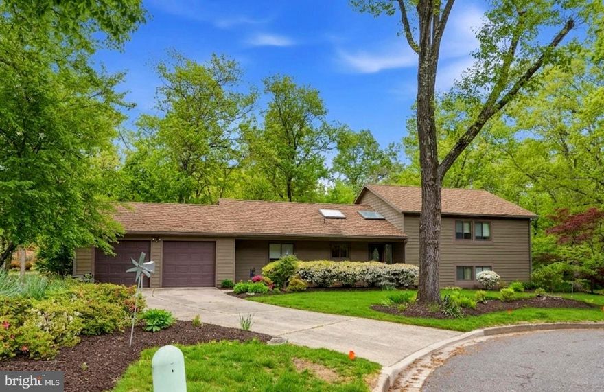 Nestled on a quiet cul-de-sac in the sought-after Village of Hickory Ridge, this beautifully maintained contemporary home offers a seamless blend of comfort, style, and peaceful living. A welcoming covered front porch sets the tone, inviting you into a space thoughtfully designed for both everyday living and effortless entertaining.

The main level opens to a bright, airy living room highlighted by soaring vaulted ceilings, a center fireplace, wall of new sliding doors, and an abundance of natural light. This inviting space flows seamlessly into the dining area, creating an open-concept layout ideal for both daily living and gatherings. Nearly new sliding glass doors open to a recently added walk-down Trex deck off the main level, less than a year old, leading to a patio and fully fenced backyard. With beautiful front and rear landscaping, blooming azalea bushes, and a private setting, the outdoor space is perfect for relaxing or entertaining.

The kitchen is both stylish and functional, featuring rich cabinetry, granite countertops, stainless steel appliances, and a soaring ceiling with skylights that fills the space with natural light. Its thoughtful layout makes it ideal for both daily living and hosting.

Upstairs, the primary suite serves as a peaceful retreat with new carpet and an updated ensuite bathroom. A full hall bathroom is accompanied by two additional generously sized bedrooms that offer flexibility for family, guests, or a home office.

The lower level expands your living space with a large family and recreation room, another full bathroom, and a fourth bedroom. Walkout access provides even more connection to the backyard and outdoor living areas.

Additional highlights include a two-car garage, a double-wide driveway, and mature tree-lined privacy. Fresh neutral paint and brand-new carpet throughout make this home truly move-in ready.

Ideally located just moments from the Village Center and top-rated schools, this home offers the perfect balance of convenience and tranquility. Whether you are enjoying a quiet morning coffee, hosting friends, or simply unwinding at the end of the day, every space is designed to feel like home.

This is a rare opportunity to own a stylish and well-appointed home in one of Hickory Ridge’s most desirable neighborhoods.