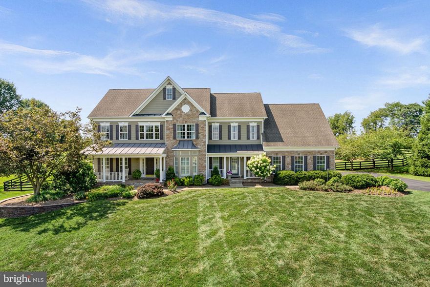 Highest and best due by 9pm 8/16 
Exceptional Estate Home!
Welcome to this exquisite residence nestled in the highly sought-after Wright Farm neighborhood of Purcellville, where refined craftsmanship meets resort-style living. Set on a beautifully landscaped 4.54 acre lot, this property offers a serene retreat with a sparkling swimming pool, a charming pergola, and vibrant gardens that bloom throughout the summer. Enjoy composite decking with multiple seating areas overlooking the pool and expansive acreage—perfect for relaxing, entertaining, or simply taking in the peaceful surroundings and unforgettable sunsets. A dedicated pool house and a separate outbuilding provide convenience for outdoor entertaining and garden care. Spacious  3 car side load garage offers ample room for vehicles, storage and hobbies.
The inviting covered front porch—perfect for rocking chairs and your favorite beverage—sets the tone for the warmth and elegance found throughout. Step inside to a grand two-story foyer adorned with custom trim work, setting the tone for the home's timeless elegance. The foyer is flanked by a formal living room and a stylish dining room featuring a bay window, perfect for hosting gatherings. A spacious main-level office overlooks the lush yard, offering a peaceful workspace. Plantation shutters on the main level add a touch of sophistication and privacy.
The heart of the home is a dramatic two-story family room with a floor-to-ceiling stone fireplace, a coffered ceiling, and soaring clerestory windows that bathe the space in natural light. This inviting area flows seamlessly into the breakfast room and gourmet kitchen, designed for both entertaining and everyday living. The kitchen boasts abundant cabinetry, dual ovens, expansive countertops, a center island accented with pendant lighting, and a bright walk-in pantry.
Additional main-level amenities include a large mudroom and a well-appointed laundry room with built-in storage, a utility sink, and a private exterior entrance—ideal for busy households.
Dual staircases lead to the upper level, where the luxurious primary suite awaits. This serene retreat features an adjacent sitting room, two walk-in closets, and a beautifully updated spa bath with a stand-alone soaking tub. An en-suite bedroom sits across the hall, while two additional bedrooms share a Jack-and-Jill bath, offering comfort and privacy for family and guests.
The walk-out basement expands the living space with a generous recreation room, bar area, pool table space, exercise area, full bath, den or fifth bedroom, and ample storage.
This remarkable home offers a rare combination of elegance, functionality, and outdoor beauty—an ideal sanctuary in one of Purcellville’s most desirable communities.