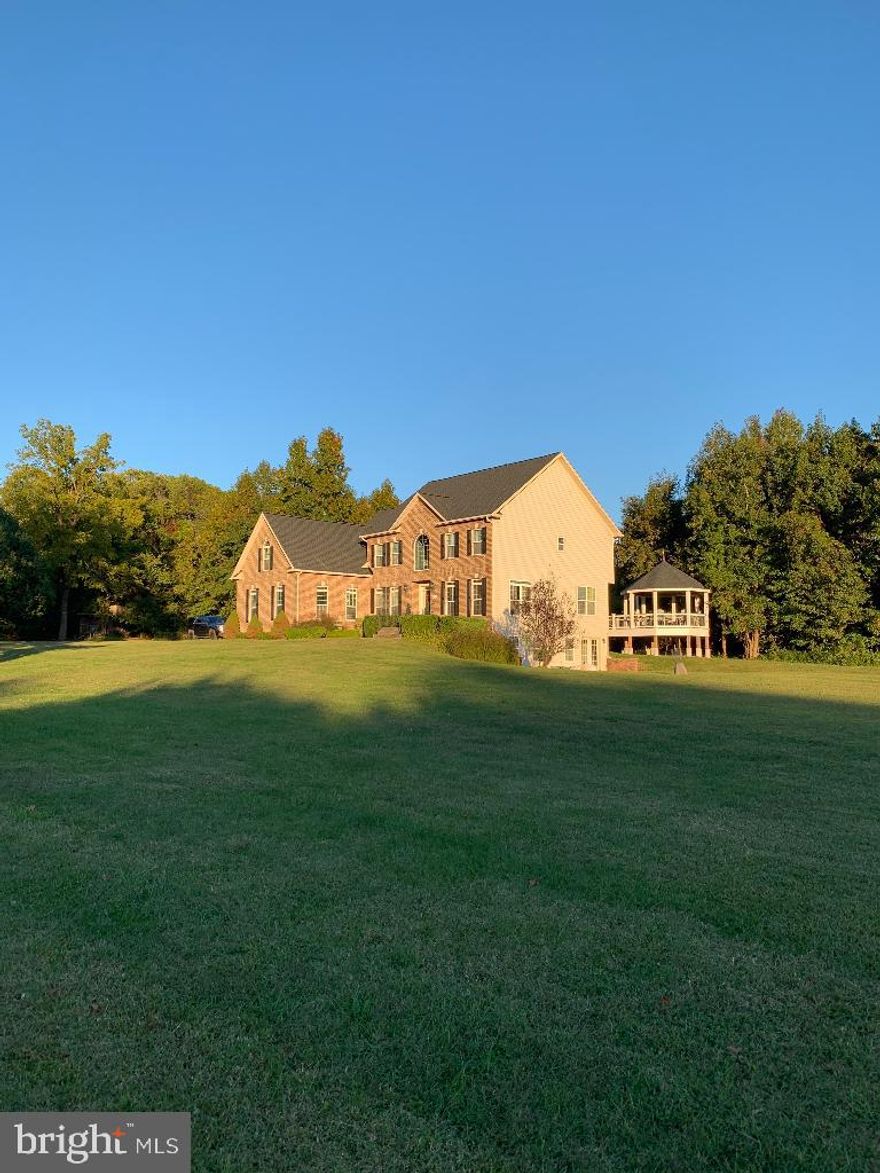 Turn Key dog boarding facility (24 runs) on property! Five horse paddocks with two run-in sheds and small barn. 21 acres with fields, woods, large pond with beautiful stone waterfall. New roof, gutters, shutters: Spring 2022 New hardwood flooring 2nd floor and one staircase Fall 2022 New HVAC unit and furnace, 2022; 2nd HVAC unit replaced 2021 Kennel HVAC unit replaced 2020 New 75 gal hot water heater 3/2024 New Maytag washer and dryer in kennel 5/2024 House septic and kennel septic pumped 5/2024 New professionally designed closets for all four bedrooms, including 23' primary closet. New and HUGE Trex deck with gazebo overlooking fields. All new paint and fixtures throughout! Ceramic tile and hardwood flooring throughout, no carpet. Basement has new kitchen with full-size stainless steel appliances and granite countertops, new stacking washer/dryer, full bathroom, walkout/slider, ceramic tile flooring. Work from home...operate boarding kennel, board horses, potential for wedding venue Please note: boarding kennel is currently in operation and accepting reservations throughout the year.