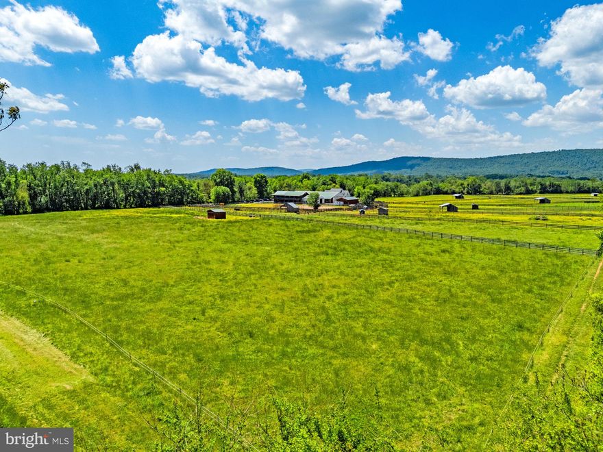 Act fast to acquire your special 7 acre parcel located in Northwestern Loudoun County which is a beautiful area of rolling hills, mountain views, horse farms and historic places. Tucked away off the main road, the majority of the land is cleared and there are mature woods on three sides offering shade and privacy. A gravel driveway is in place. No HOA. Zoned AR-1. Currently, neighbor’s horses and cows  are on the property which is in ‘Farm Use’, but there is no lease in place. The well is installed (previously tested at 20 GPM) and the soil has been tested and two drain fields sited for a conventional septic system. The property corners are all staked but some may be hidden with overgrowth.

Ideally located away from the hustle and bustle, yet convenient to major roads, the property can be accessed from a variety of directions- from Berlin Turnpike (Rt. 287), Purcellville Rd. or from Rt. 9 (Charles Town Pike) near Hillsboro then onto Mountain Rd. to Morrisonville Rd.  Shop in Purcellville, Leesburg or the new Lovettsville Co-op Market. Lovettsville has some great cafes, restaurants, and shops, not to mention the annual Oktoberfest held in late September. Nearby historic Waterford, (a National Historic Landmark) is a charming well-preserved 18th and 19th century village that hosts the fantastic Waterford Fair each year in October. Cross over the Potomac River to visit Harper’s Ferry or Brunswick.  A commuter train to Washington D.C. is available from Brunswick or Point of Rocks. 
Whether you build your home here now or later, this a great place to relax. Plant a garden, enjoy the fresh air, sunlight and mountain views.

The Amish-made log cabin can be purchased separately or it will be removed. Cabin has 2 bedrooms plus a loft and 1 full bathroom with a large walk-in shower. Included are the kitchen appliances and tiny wood stove that can be used for cooking as well. The cabin is plumbed, wired for electricity and has heating and air conditioning, but no utilities are connected at present. The log cabin was manufactured by ‘Lancaster Log Cabins’ as part of their log park model cabins series and is the ‘Rancher’ with loft model.