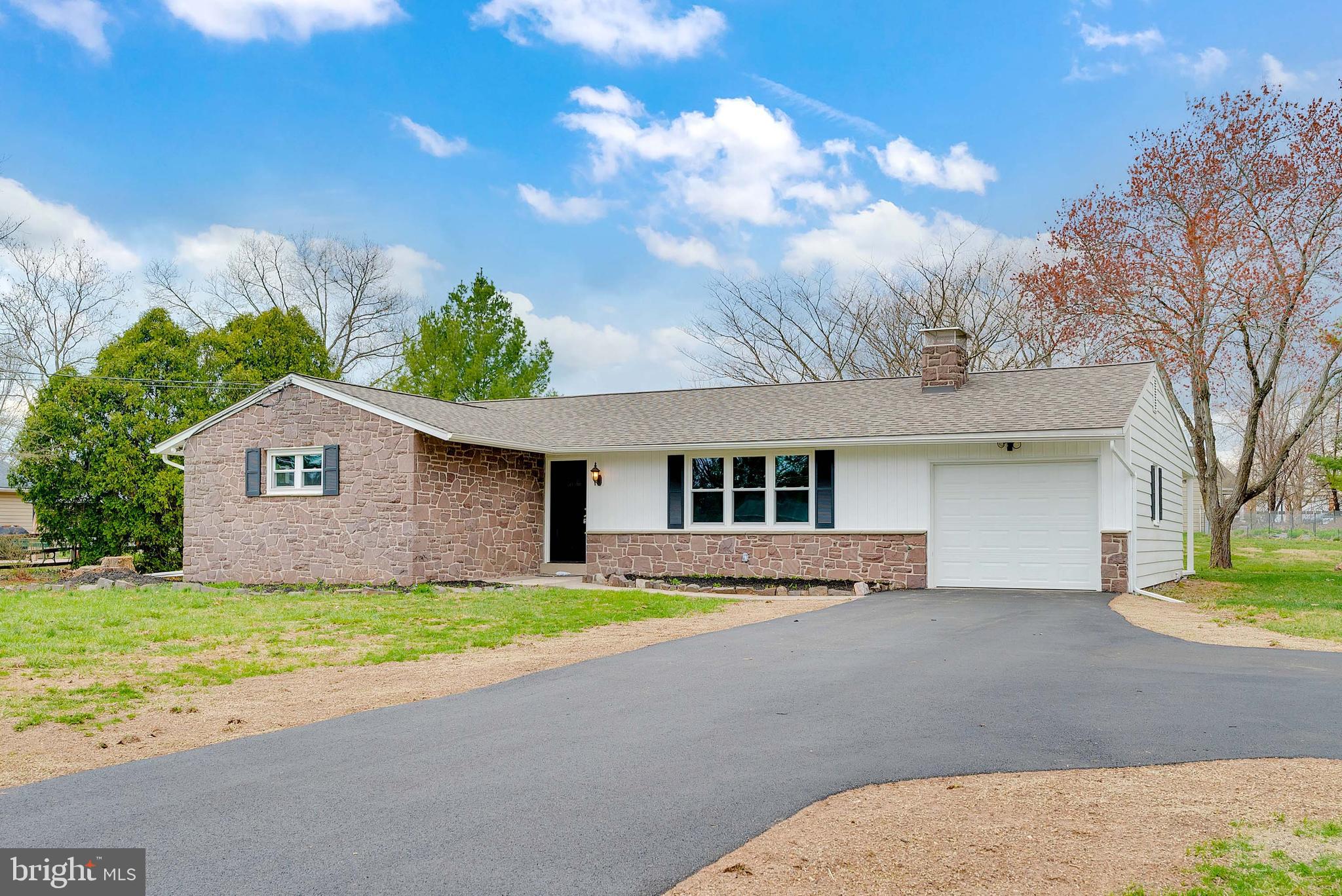 Don’t miss out on this beautifully updated 3-bedroom, 2-full-bathroom rancher, nestled on nearly 1 acre in the heart of Harleysville, PA. Situated in the highly sought-after Souderton School District, this home offers the perfect blend of modern updates and charming details. As you approach the home, you’ll immediately appreciate the new driveway that provides ample parking for up to 5 cars. The exterior boasts fantastic curb appeal with new shutters, a gorgeous front door, updated garage door, new siding, and soffits. Inside, you’ll find a completely remodeled kitchen featuring white cabinets, sleek granite countertops, new stainless steel appliances, and a beautiful tile backsplash. The separate breakfast/dining area adds a cozy touch. The kitchen flows seamlessly into the spacious formal living room, which is highlighted by a stone, wood-burning fireplace and newly installed engineered hardwood floors that run throughout the entire home. A standout feature of the main floor is the versatile family room located off the back of the kitchen, complete with a full bathroom and French doors that lead to the rear patio. This room is ideal for use as an in-law suite, home office, or additional living space. The west wing of the home includes two generously sized guest bedrooms, a beautifully upgraded full bathroom with a tile shower, and new vanities. The primary suite is a true retreat, featuring double closets and more of the gorgeous hardwood flooring that flows throughout the home. Notable interior upgrades include new windows, central air, a 200-amp electric service, black interior doors with new hardware, fresh drywall, and freshly painted walls, along with upgraded trim work throughout the home. The basement offers a spacious workshop area, plenty of storage, and the potential for additional living space if desired.
Step outside to enjoy the covered porch off the family room, offering a peaceful view of the large, open backyard. The expansive yard provides plenty of space for play and entertainment. If you’re an avid gardener, you’ll love the two large fenced-in gardens, perfect for growing vegetables, flowers, or creating a designated play or pet area. At the rear of the property, you’ll find a large outbuilding with endless possibilities. Use it as a home workshop, garage for extra vehicles, ATV storage, lawn equipment, gym, or even a golf simulator area. This home’s location is incredibly convenient, just seven minutes from the Pennsylvania Turnpike Northeast Extension, with easy access to the Lehigh Valley, Plymouth Meeting, Philadelphia, and more. The YMCA, Walmart, and a variety of great restaurants are all within five minutes, adding to the appeal of this fantastic property.