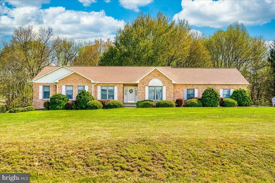Welcome to 1570 Wood Villa Drive! Nestled on 3 scenic acres with sweeping views of picturesque farmland. This inviting home offers the perfect blend of privacy and comfort. The spacious front yard and brick exterior create a warm and welcoming first impression.  Inside, you’ll find a bright and roomy foyer flanked by a formal living room and a separate dining room—ideal for both everyday living and entertaining. The well-appointed eat-in kitchen boasts granite countertops, stainless steel appliances, and ample cabinetry. Anyone who loves to cook will enjoy this space!  A charming bay window fills the eat-in area with natural light and views of the backyard.  Conveniently located just off the kitchen is a laundry room with additional pantry storage, access to the backyard, and a half bath, adding extra convenience to this home.  The expansive family room, which would serve as the heart of the home, is the place everyone will want to gather!  This room flows seamlessly into a beautiful sunroom—perfect for enjoying peaceful mornings or relaxing evenings while taking in panoramic views of the surrounding landscape.  This home offers two generously sized secondary bedrooms, both with hardwood floors and including one with a walk-in closet. The spacious primary suite features hardwood floors,  a walk-in closet, and an ensuite bath complete with a double vanity, walk-in shower, and soaking tub.
The partially finished basement provides endless possibilities for customization! Ideal for a recreation room, additional living space, or hobby area. There is abundant storage, a rough-in for a future half-bath, and a walkout to the backyard.  If you need extra space for projects, the large garage features a workshop area for the hobbyist!   Offering the ease of one-level living on a serene, private lot with stunning farmland views, this property is one you will want to see!  Schedule your private tour today!