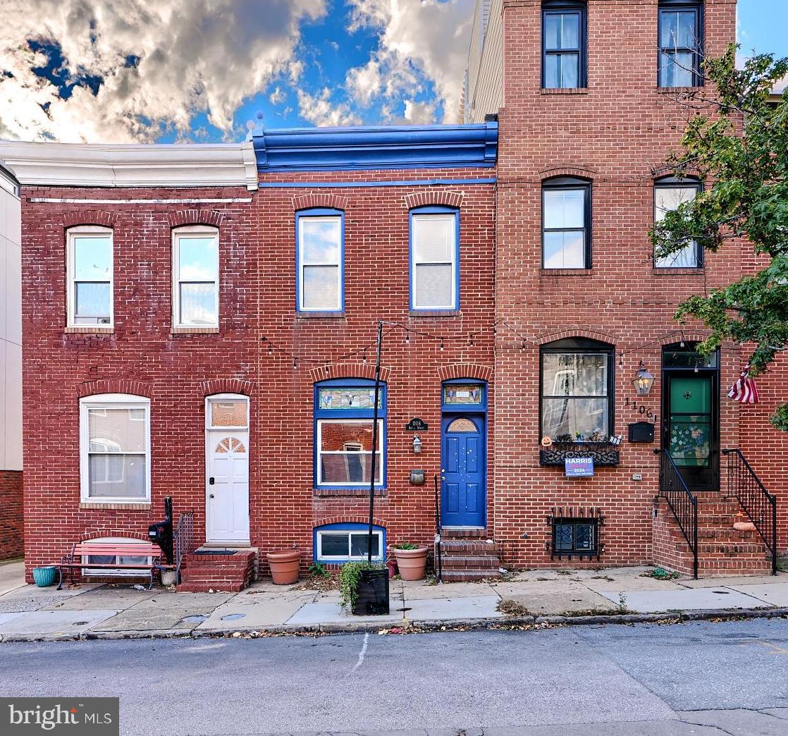 Welcome to 1108 S Baylis Street in the heart of Baltimore’s vibrant Canton neighborhood, this 2-bedroom, 2.5-bath townhome offers PARKING, comfort and style. The spacious open floor plan features hardwood floors, exposed brick accents, and large windows that flood the home with natural light. The sleek kitchen includes all major appliances, tile countertops, and a breakfast bar that opens to the living and dining areas, making it ideal for entertaining.  Walk out the rear to a private deck area with PARKING that has stairs up to a ROOFTOP DECK. The finished basement adds additional living space, perfect for a home office or media room.
Situated just steps from Canton Square and the waterfront, this home provides easy access to some of the best restaurants, bars, and shopping Baltimore has to offer. Enjoy leisurely walks along the harbor or a quick commute to downtown via nearby public transportation or major highways. With a private rooftop deck offering stunning city and water views, this home is perfect for those who enjoy outdoor living and entertaining. Ample street parking is available, ensuring convenience in this lively, walkable community.
