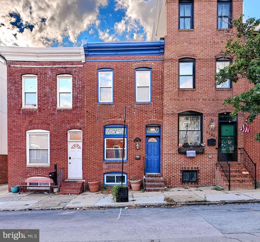 Welcome to 1108 S Baylis Street in the heart of Baltimore’s vibrant Canton neighborhood, this 2-bedroom, 2.5-bath townhome offers PARKING, comfort and style. The spacious open floor plan features hardwood floors, exposed brick accents, and large windows that flood the home with natural light. The sleek kitchen includes all major appliances, tile countertops, and a breakfast bar that opens to the living and dining areas, making it ideal for entertaining.  Walk out the rear to a private deck area with PARKING that has stairs up to a ROOFTOP DECK. The finished basement adds additional living space, perfect for a home office or media room.
Situated just steps from Canton Square and the waterfront, this home provides easy access to some of the best restaurants, bars, and shopping Baltimore has to offer. Enjoy leisurely walks along the harbor or a quick commute to downtown via nearby public transportation or major highways. With a private rooftop deck offering stunning city and water views, this home is perfect for those who enjoy outdoor living and entertaining. Ample street parking is available, ensuring convenience in this lively, walkable community.