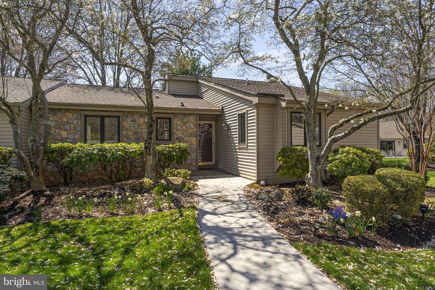 Welcome 483 Eaton Way! This well-maintained end-unit is nestled within the desirable Eaton Village at Hershey’s Mill, which offers the added benefit of the village’s own private pool. Step inside to a bright and inviting main living space where gleaming hardwood floors, recessed lighting, and a classic wood burning fireplace create a warm and welcoming atmosphere. The built-in corner cabinet and sideboard offer storage. Large windows fill the room with natural light, while sliding glass doors lead directly to the new composite deck with views of the mature, well-maintained grounds and the golf course—perfect for effortless indoor-outdoor living, entertaining and enjoying morning coffee or evening relaxation. The spacious eat-in kitchen features abundant cabinetry, newer appliances, generous counter space, and a functional center island ideal for meal preparation or casual gatherings. The laundry is conveniently located in the kitchen. The large primary suite provides a peaceful retreat with a beautifully maintained en-suite bath with glass-enclosed shower and large vanity plus a custom walk-in closet offering excellent organization and storage. The second bedroom provides flexible space for guests, a home office, or hobbies, while the full hall bath adds convenience. The finished lower level expands the home’s versatility with a large recreation room—perfect for movie nights, game days, or visiting family. Built-in cabinetry adds character and functionality, while additional unfinished space provides abundant storage or room for a workshop or fitness area. This unit also offers a one-car detached garage just outside the front door. Living in Hershey’s Mill means enjoying an active, low-maintenance lifestyle with 24-hour gated security, a championship golf course, walking trails, tennis and pickleball courts, community center activities, and beautifully maintained grounds—all just minutes from the shops, dining, and conveniences of West Chester. A wonderful opportunity to enjoy space, comfort, and community in one of Chester County’s most sought-after active adult neighborhoods.