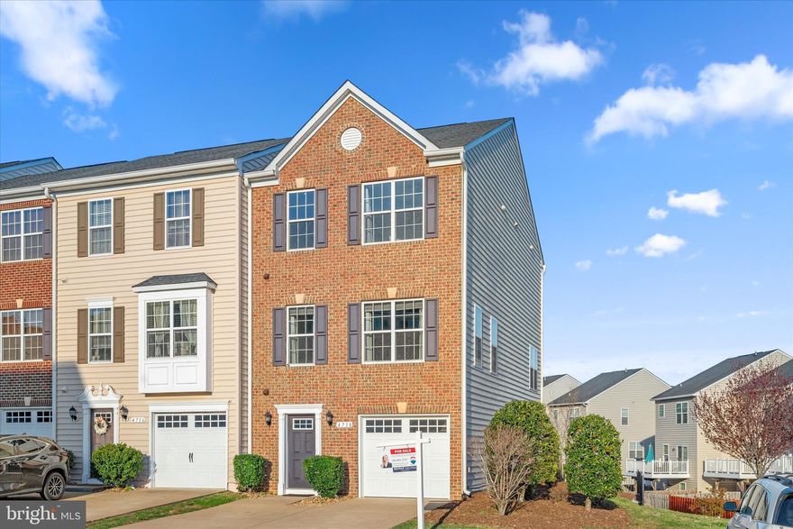 FORMER MODEL HOME! This 3-level luxury end unit townhome has brick front and every bell and whistle any homeowner can want from stunning hardwood floors to gourmet kitchen with granite countertops, kitchen island and stainless steel appliances to finished walkout basement to a low-maintenance composite deck to all of the designer touches! Fresh paint throughout! Brand new basement carpet! Spacious Garage! Don't settle for less than the best! Hurry this one won't last!