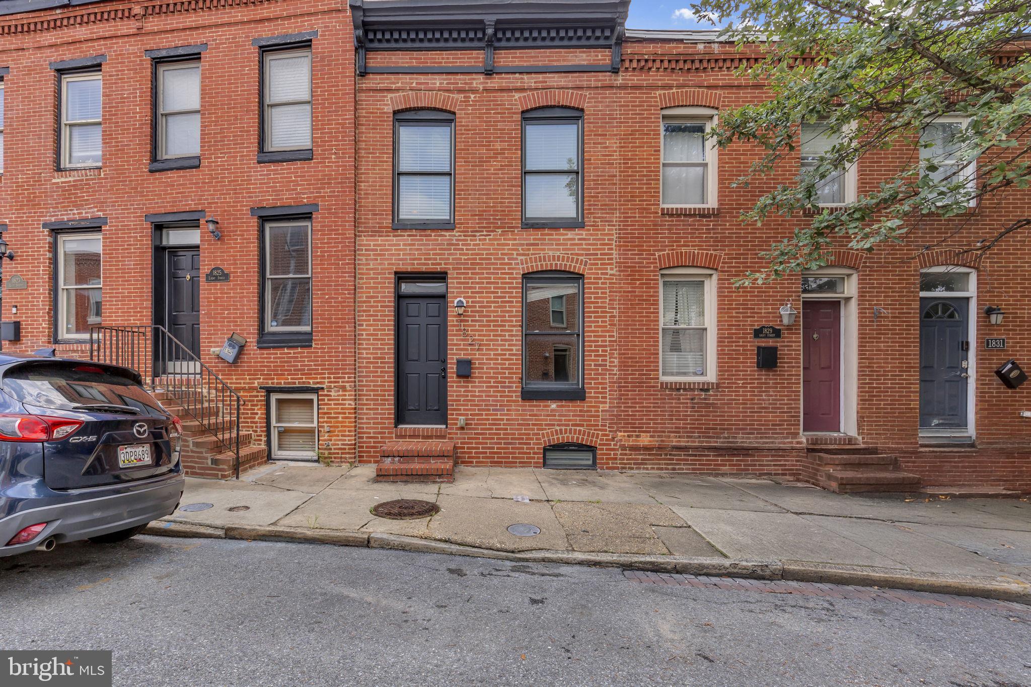 This charming Federal Hill townhome, originally built in 1900 and tastefully renovated in 2014, blends timeless character with modern comforts. Set in the heart of one of Baltimore’s most vibrant and historic neighborhoods, it’s surrounded by a rich food scene and eclectic local shops. Just a short stroll away, you’ll find Federal Hill Park, known for its sweeping views of the Inner Harbor and Downtown skyline, and Riverside Park, with its treasured green space with walking paths, ballfields, pool, playgrounds, and community events. The neighborhood is alive with trendy boutiques, curated vintage stores, and specialty shops, while its celebrated dining culture offers everything from chef‑driven restaurants and stylish wine bars to classic pubs, rooftop lounges, and cozy cafés. Stepping inside this historic home, the rooms are accentuated with an original exposed brick wall and distressed hardwood flooring that flows throughout both the main and upper levels. The living room sits at the front of the home, flooded with natural light. Toward the back, the beautifully renovated kitchen features granite countertops and an extended breakfast bar with seating for five or more, illuminated by chic pendant lighting. Just beyond, the kitchen opens directly to a lower deck on the main level—perfect for grilling and outdoor dining. Upstairs, you’ll find two spacious bedroom suites, each with access to a fully renovated bathroom offering modern finishes and tub/shower combinations. The rear bedroom suite offers a special bonus with direct access to a private upper‑level deck overlooking the backyard. The lower level features a versatile finished room with custom epoxy flooring, ideal for use as a family room, guest space, or home office. This level also includes a full bathroom and a convenient stackable washer and dryer. With historic charm, renovated throughout, two outdoor decks, and an unbeatable location surrounded by parks, shopping, and an incredible dining scene, this home is a true gem in the heart of Federal Hill!
