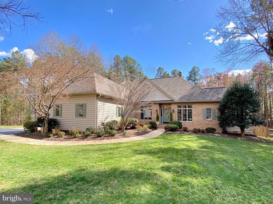 Gorgeous turn-key custom Dream Home nestled in an established section, overlooking a wooded conservation area in the luxury community of Fawn Lake. Designed for casual main level living, this charming brick home offers a semi-open floor plan filled with beautiful architectural details at every turn. A welcoming foyer ​is anchored by a beautiful Dining Room with large windows, ​and an inviting Living Room. Sitting at the center of the home is a ​stunning Family Room with a ​wood burning fireplace ​flanked by custom built-in bookcases and media cabinetry. French Doors lead​ to a spacious deck, offering extended living and entertaining opportunities while overlooking the peaceful backyard. The gourmet Kitchen with ​cherry cabinets, stainless steel appliances, ​silestone counters and tile backsplash features an incredible sunlight Breakfast ​area ​with access to the rear deck​ and the beautiful Courtyard patio. Both provide tranquil views of nature and the perfect setting for relaxing outdoor living. The gracious Main Level Owner's Suite features two walk-in closets and luxurious Spa Bath with soaking tub, tile shower and ​dual vanit​ies plus a makeup vanity. Two additional spacious bedrooms with walk-in closets are anchored by a ​Full Hall Bath.  A Convenient Laundry Room with ​utility sink and ​extra storage, ​along with a charming Powder Room completes the Main Level. A​n open staircase leads ​downstairs to the huge finished basement. Designed for entertaining, the open living space offers a huge Great Room, two multi-function rooms that can serve as a gym, office, workshop or bedroom. A beautiful Full Bath can mak​e it an ideal and a peaceful retreat for guests. ​The large utility room provides plenty of storage space. Meticulously maintained, the home featur​es a New Roof ​installed in 2021, along with new gutters. The new energy efficient HVAC was installed in 2021. The ​beautifully landscaped grounds are easily maintained with the in​-ground irrigation system​ installed on the property. 
​Custom built by renowned Sagun Homes, this charming home is perfectly nestled at the end of a cul-de-sac on 1.43 acres surrounded by mature hardwood and blooming trees providing wonderful views of nature and privacy! Located ​in a desirable established area, right in the heart of ​Fawn Lake! Conveniently located steps away to the walking and biking path that leads to the pool, beach, tennis courts, and the Fawn Lake Country Club! The beautiful Luxury Fawn Lake Community offers amazing amenities such as a boating recreational lake, beach, Arnold Palmer designed golf course, tennis courts, baseball and soccer fields, dog park, volleyball courts, walking trails, Community ClubHouse, marina, fitness center, restaurants, Country Club, playgrounds, and so much more! Located in the countryside near the town of Fredericksburg, surrounded by park lands and only a few miles to the farm market, wineries, and award winning breweries!