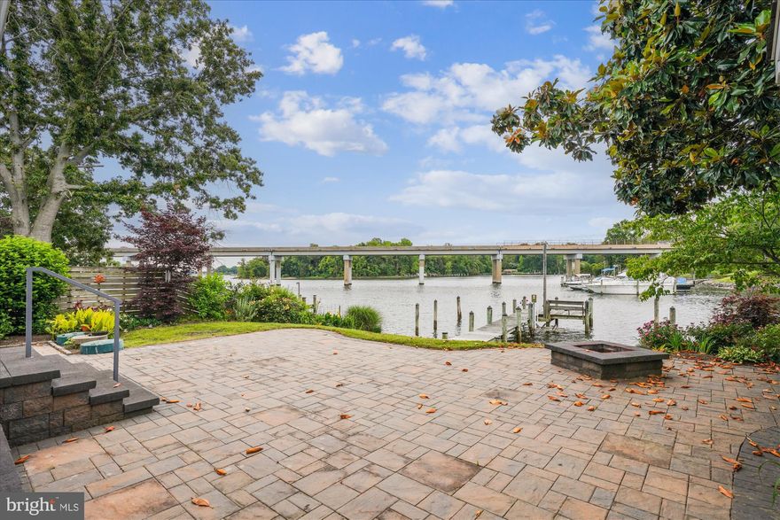 Renovated kitchen boasting granite counters and white cabinets. Open floorpan with extensive patio pavers to make a beautiful sitting area to take in the views of Patuxent River.  New HVAC unit installed Aug 2025! DIRECT RIVER ACCESS with your private pier with electric and jet ski lift. Perfectly appointed two bedrooms with two full bathrooms, large and open great room off the kitchen with a large and open great room off the kitchen with unobstructed water views with your own private pier. •••Please note, the detached garage with screened in porch belongs to the neighbors home. It is not on this property, please do not enter••• The shed that opens to the patio does belong to this home. Appraisal in hand for $600,000