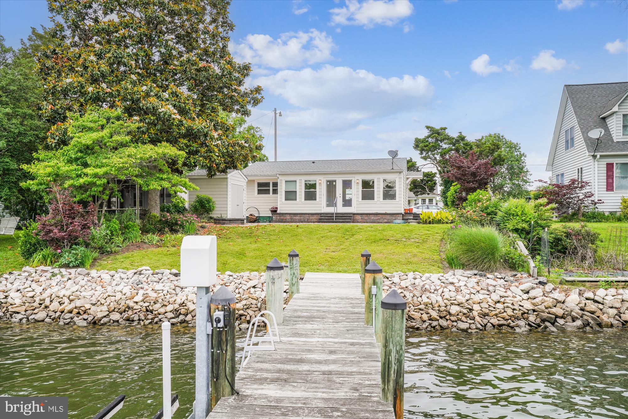 Renovated kitchen boasting granite counters and white cabinets. Open floorpan with extensive patio pavers to make a beautiful sitting area to take in the views of Patuxent River. DIRECT RIVER ACCESS with your private pier with electric and lift. Perfectly appointed two bedrooms with two full bathrooms, large and open great room off the kitchen with a large and open great room off the kitchen with unobstructed water views with your own private pier. •••Please note, the detached garage with screened in porch belongs to the neighbors home. It is not on this property, please do not enter••• The shed that opens to the patio does belong to this home.