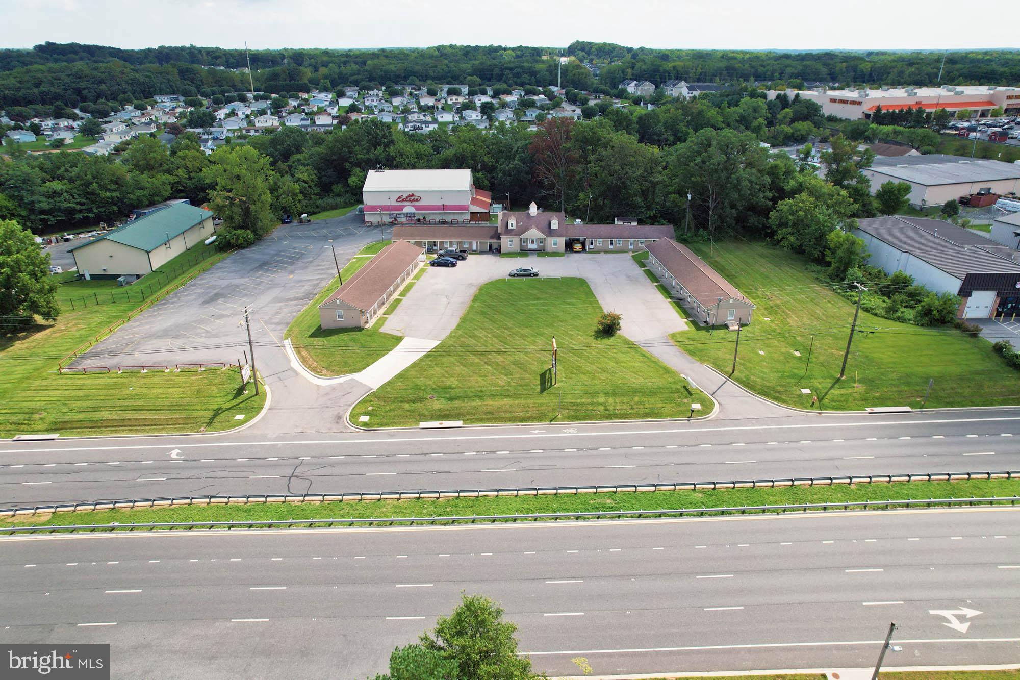 REAL ESTATE AUCTION featuring ON SITE and SIMULCAST ONLINE BIDDING!! Online Bidding Opens - Monday, July 7, 2025. Live On Site Auction - Thursday, July 10, 2025 at 12:00 Noon. List Price is opening bid only. Live Auction Bidders – a $100,000 deposit, payable by cashier’s check, will be required of the purchaser at time and place of sale. Online Auction Bidders – a $100,000 deposit, payable by cashier’s check or wire, will be required of all online bidders prior to the start of the live auction. The deposit will be held in escrow until the completion of the auction and will be retained from the winning bidder.
10025 Pulaski Highway comprises a long time family-owned commercial property currently being operated as a 24-room roadside motel and adult nightclub. Located in the White Marsh area of eastern Baltimore County, the site encompasses two parcels totaling 3.61 acres improved by a total of 4 buildings. Property zoning is predominantly Business Roadside (BR-AS & BR-IM), with a portion zoned Light Manufacturing (ML-AS & ML-IM), providing a wide array of potential site uses. With over 400′ of road frontage along Pulaski Highway (US-40), close to both White Marsh Boulevard (MD-43) and I-95, the property benefits from a substantial amount of daily vehicle traffic – 30,663 cars per day (AADT) according to MDOT transportation statistics.
Development in the area is and has been among the most robust in the Baltimore metropolitan region for decades. Major retailers, including Costco, Home Depot and CarMax, are in close proximity, as are a number of significant local businesses, warehouses and logistics centers. A number of new residential developments are also ongoing throughout the White Marsh Boulevard and I-95 corridors nearby.
Whether intending to fully redevelop the site or continue ongoing business operations, the auction provides a phenomenal opportunity for both real estate investors and business owners alike to purchase a high-exposure site with advantageous zoning.