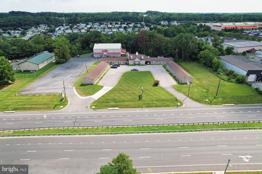 REAL ESTATE AUCTION featuring ON SITE and SIMULCAST ONLINE BIDDING!! Online Bidding Opens - Monday, July 7, 2025. Live On Site Auction - Thursday, July 10, 2025 at 12:00 Noon. List Price is opening bid only. Live Auction Bidders – a $100,000 deposit, payable by cashier’s check, will be required of the purchaser at time and place of sale. Online Auction Bidders – a $100,000 deposit, payable by cashier’s check or wire, will be required of all online bidders prior to the start of the live auction. The deposit will be held in escrow until the completion of the auction and will be retained from the winning bidder.

10025 Pulaski Highway comprises a long time family-owned commercial property currently being operated as a 24-room roadside motel and adult nightclub. Located in the White Marsh area of eastern Baltimore County, the site encompasses two parcels totaling 3.61 acres improved by a total of 4 buildings. Property zoning is predominantly Business Roadside (BR-AS & BR-IM), with a portion zoned Light Manufacturing (ML-AS & ML-IM), providing a wide array of potential site uses. With over 400′ of road frontage along Pulaski Highway (US-40), close to both White Marsh Boulevard (MD-43) and I-95, the property benefits from a substantial amount of daily vehicle traffic – 30,663 cars per day (AADT) according to MDOT transportation statistics.

Development in the area is and has been among the most robust in the Baltimore metropolitan region for decades. Major retailers, including Costco, Home Depot and CarMax, are in close proximity, as are a number of significant local businesses, warehouses and logistics centers. A number of new residential developments are also ongoing throughout the White Marsh Boulevard and I-95 corridors nearby.

Whether intending to fully redevelop the site or continue ongoing business operations, the auction provides a phenomenal opportunity for both real estate investors and business owners alike to purchase a high-exposure site with advantageous zoning.